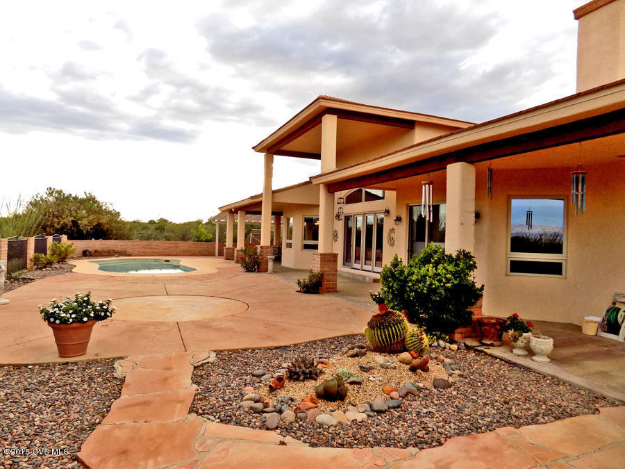 Magnificent Custom Home w/Incredible Views! This solar 4bd/den/3.5ba home w/pool & 4 car gar is a rare find. Unique features to include 3-zoned radiant heat, soaring 18' ceiling @ great room, 2 FP, lock out gst. Suite (Bd, Ba + sitting area off patio) expansive east patio doors/windows capturing the panoramic views and so much more! In addition-Mueller steel constructed insulated gar/workshop for RV/car storage or restoration. (Will hold min 20 cars on one level) RV hookups, 10' and 12' doors, 1/2 ba, airlines exhaust fans, 200 amp service. Addt'l 16'x24' garage for detailing & 17'x54' carport easily converted to 6 horse stalls. A must see!!