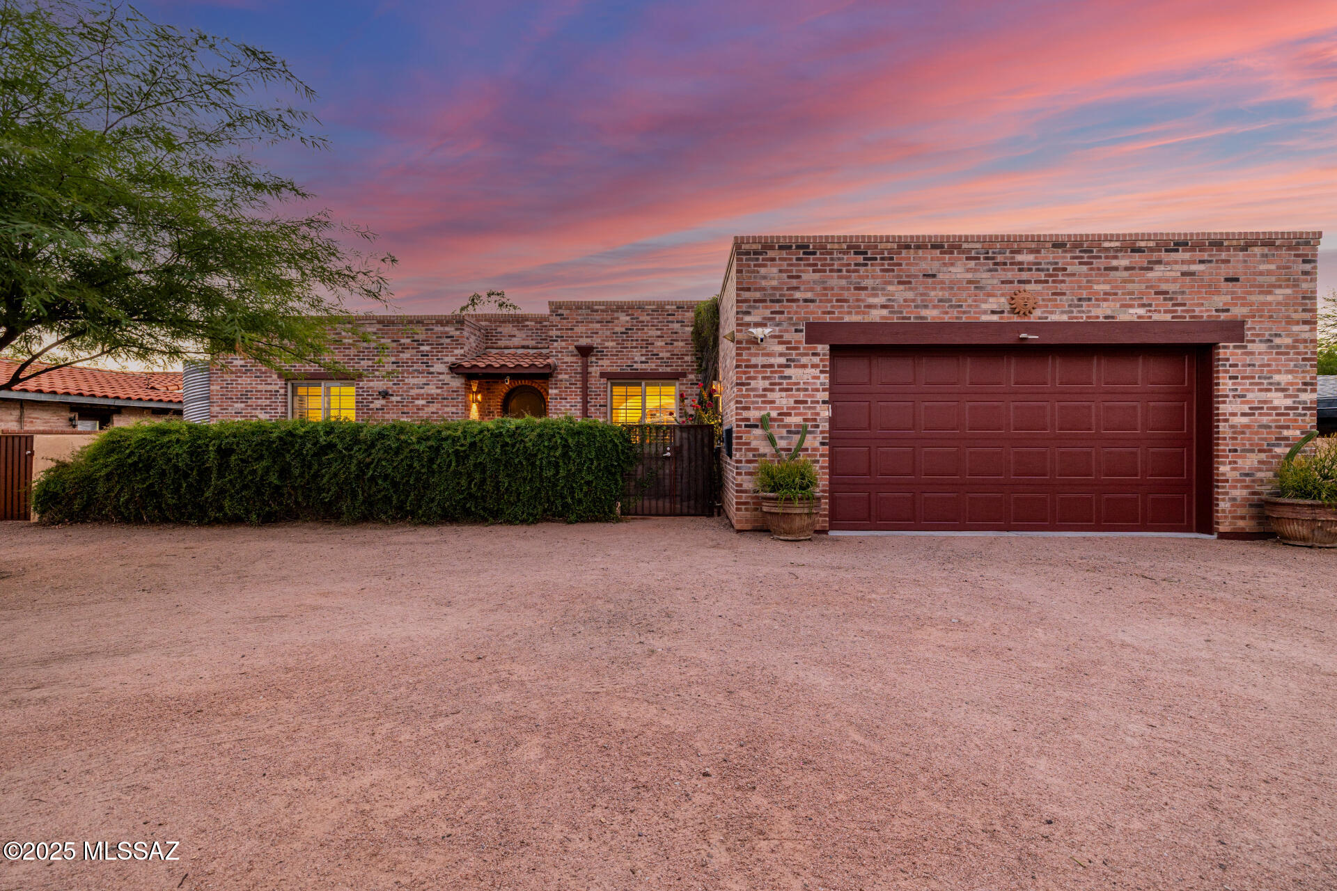 Step into the charm of Tucson's architecture heritage with this luxury residence inspired by the famed Josias Joesler nestled on a spacious 1/3-acre lot in the heart of the city. Built in 2006 this home masterfully blends classic design with contemporary amenities. The home welcomes you with a true foyer featuring a tray ceiling and custom tile medallion, setting the tone for timeless elegance. Inside, soaring 11-foot ceilings crown the great room, while wood-clad patio doors invite natural light and open seamlessly to the pool terrace. The gourmet island kitchen is a chef's dream, adorned with knotty alder cabinetry, granite slab counters, and rich finishes. Throughout the home, all-tile flooring and fabulous Talavera sinks add both beauty and practicality. The outdoor living spaces are equally captivating. A shimmering pool lined in cobalt blue mosaic tile, relaxing spa, fire pit, and winding pathways create the ultimate entertainer's yard, perfect for gathering, stargazing, or quiet reflection. With four water-harvesting cisterns, zoned HVAC, and thoughtful insulation, the home is as efficient as it is enchanting. Completing the estate is a charming 1BR/1BA guest house with its own electric service, and a separate workshop/shed. Rear alley access offers flexibility and convenience. Situated in a walkable neighborhood near restaurants and just a bike ride from the University of Arizona, this residence blends history, artistry, and modern living into one unforgettable home.
________________________________________
