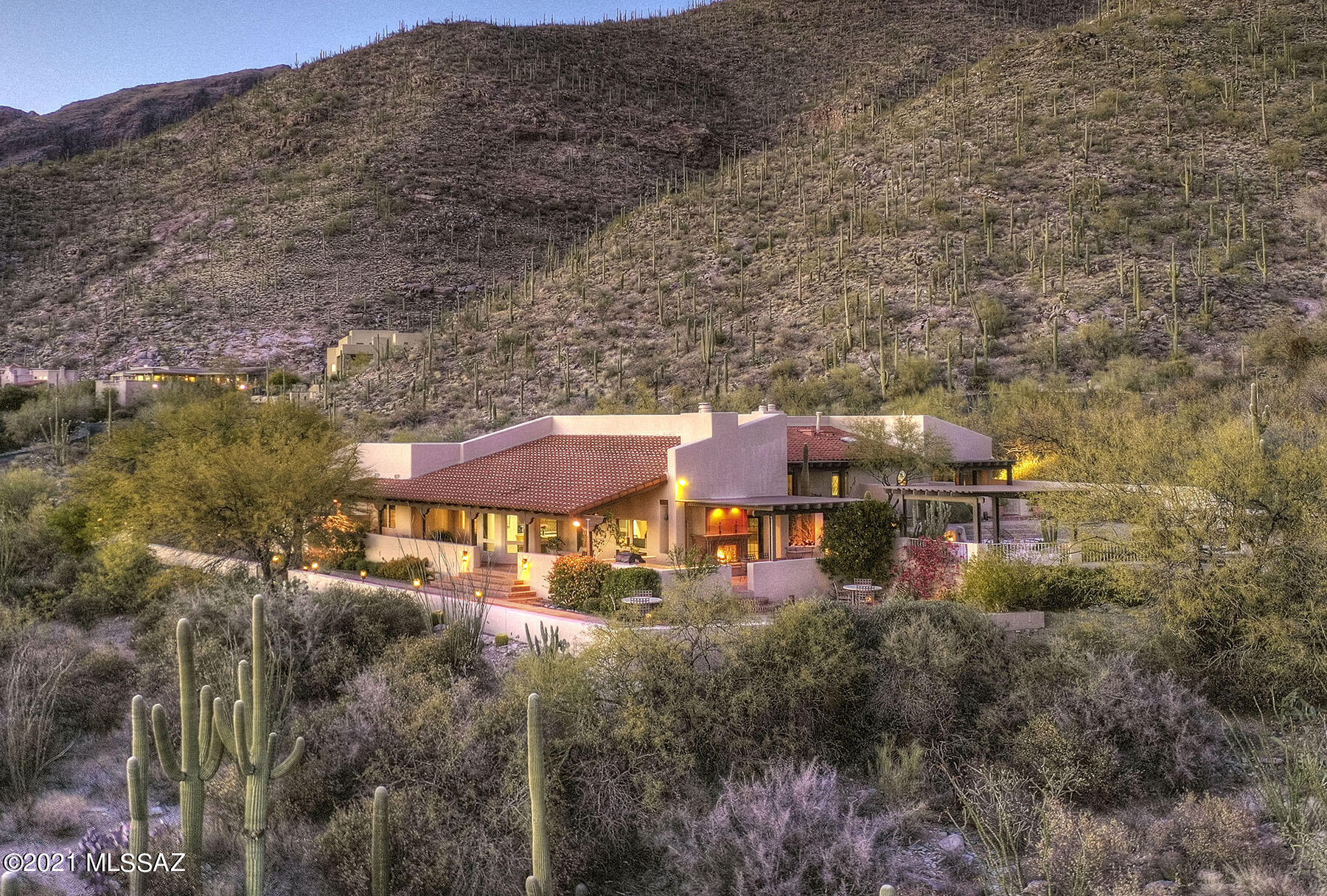 Charming  updated southwestern style
home w/breathtaking mtn & city views on very secluded 2.8 acres in prestigious gated Sin Vacas. Foyer entry, exquisite living rm w/high ceilings, 2-way  fireplace opens to den/library w/built in bookcases, walls of windows,  formal dining rm w/built in walnut buffet server, island kit w/granite countertops, stainless steel appliances, SubZero,  gas cook top w/wok, dble ovens, breakfast area opens to family rm w/stone fireplace, lg walk in pantry, beautiful travertine flrs & wood cased windows, 4 BR's (split plan), 3 BA's  (master w/granite countertops, tub, shower & entry to rear patio). Resort like living w/pebble tec gas heated pool, spa, 3 cov'd patios, BBQ, shuffle board,  lush landscaping, 3 car gar,  brick paver circular driveway, Views! Views!
