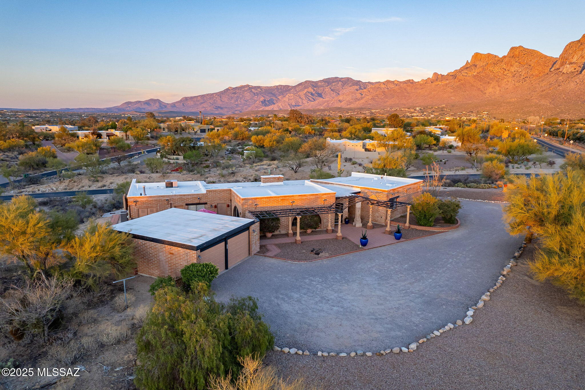 Nestled on an elevated private corner lot in the exclusive Oro Valley Estates, this custom-built Territorial Ranch-style home offers breathtaking Pusch Ridge mountain views. Featuring 4 spacious bedrooms, including 2 primary suites w/ walk-in closets, & 3 bathrooms, the split floor plan ensures privacy & comfort. Enjoy natural light streaming through large windows, high ceilings, exposed bricks, & stunning wood beam details. The gourmet kitchen boasts granite countertops & stainless-steel appliances. Tile floors throughout, a grand great room with a granite fireplace, & a private courtyard enhance the charm. Situated on over an acre with a detached 2 car garage, this home is close to golf, shopping & all the conveniences. This home blends luxury & privacy in a prestigious neighborhood. Roof recoated in May 2025