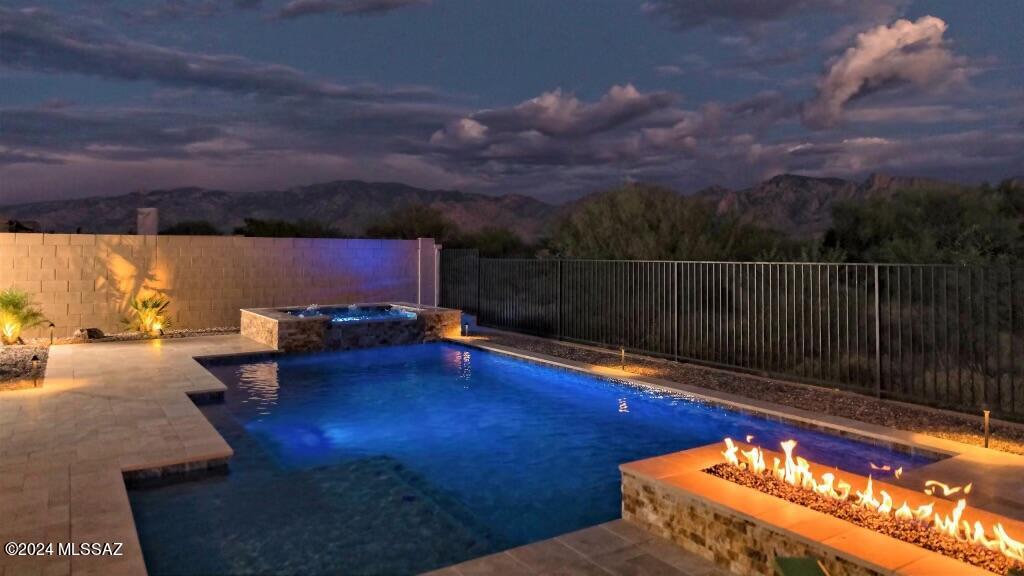 Welcome to your luxury oasis w/ breathtaking panorama views of majestic Catalina's, custom pool & hot tub. A shady private courtyard welcomes you into a single level, open concept, split floor plan offering multiple seating, a stunning chef's kitchen for hosting guests & family. Retreat into primary ensuite w/ garden tub, separate shower, double vanity & large walk-in closet. From living area, the moment you open your large sliding glass doors & step out into the fully fenced, pristine private yard, you realize you are in for something special; new dazzling pool, gazebo w/ gas stub for a BBQ to enjoy your indoor/outdoor living. Whether you are enjoying dining al fresco, sipping coffee or wine, in front of the gas fire pit, this outdoor space is bound to be the place you gravitate towards! Welcome to your private spectacular oasis with breathtaking panorama views of the majestic Pusch Ridge in the Catalina Mountains overlooking a new custom sparkling pool by Southern Arizona Pools. A spacious, shady private courtyard welcomes you, as you enter this single level, open concept, split floor plan home offering 4 bedrooms plus den & office. This home boasts multiple seating areas for relaxation and entertainment, a stunning chef's kitchen for hosting guests and family with lots of counter space and a large center island of stunning quartz countertops. The expansive kitchen incorporates a large pantry, breakfast nook, hands free faucet, deep sink, and high end stainless steel appliances; double oven & gas cooktop range.  Retreat into your lovely primary ensuite with a garden tub, separate shower, double vanity and large walk in closet. The garden tub has a self regulating heater to relax in your bath! The living room can comfortably accommodate a sectional couch, entertainment unit, coffee table, and end tables. From the living area, the moment you open your large sliding glass doors and step out into the perfectly designed, fully fenced, pristine private backyard, you realize you are in for something special. Be awestruck as you take in the new dazzling pool that sits next to your covered patio with a gas stub for a BBQ to completely enjoy your indoor/outdoor living.  Pool and hot tub are less than 1 year old. The pool & hot tub can be heated separately and the pour over waterfall is adjustable. The beautiful lighting and travertine pavers complete this perfectly designed back yard. Whether you are enjoying dining al fresco, sipping coffee or wine, or wiping away all cares in front of the gas fire pit, this outdoor space is bound to be the place you gravitate towards. This luxurious Maracay built home is a part of a gated community that backs to the Vistoso Trails Nature Preserve, a 202 acre property with 6.2 miles of walking paths winding through the Sonoran Desert vegetation and the opportunity to view an abundance of wildlife. The sought after Center Point Vistoso neighborhood provides a 6,000-square-foot luxury pool complex, interactive splash park, a community park with activity lawns, shaded play structures, butterfly garden and more. This perfectly priced, move-in ready magnificent home will move fast, come check it out today!

*Please refer to Upgrades & Improvements List in Document section!