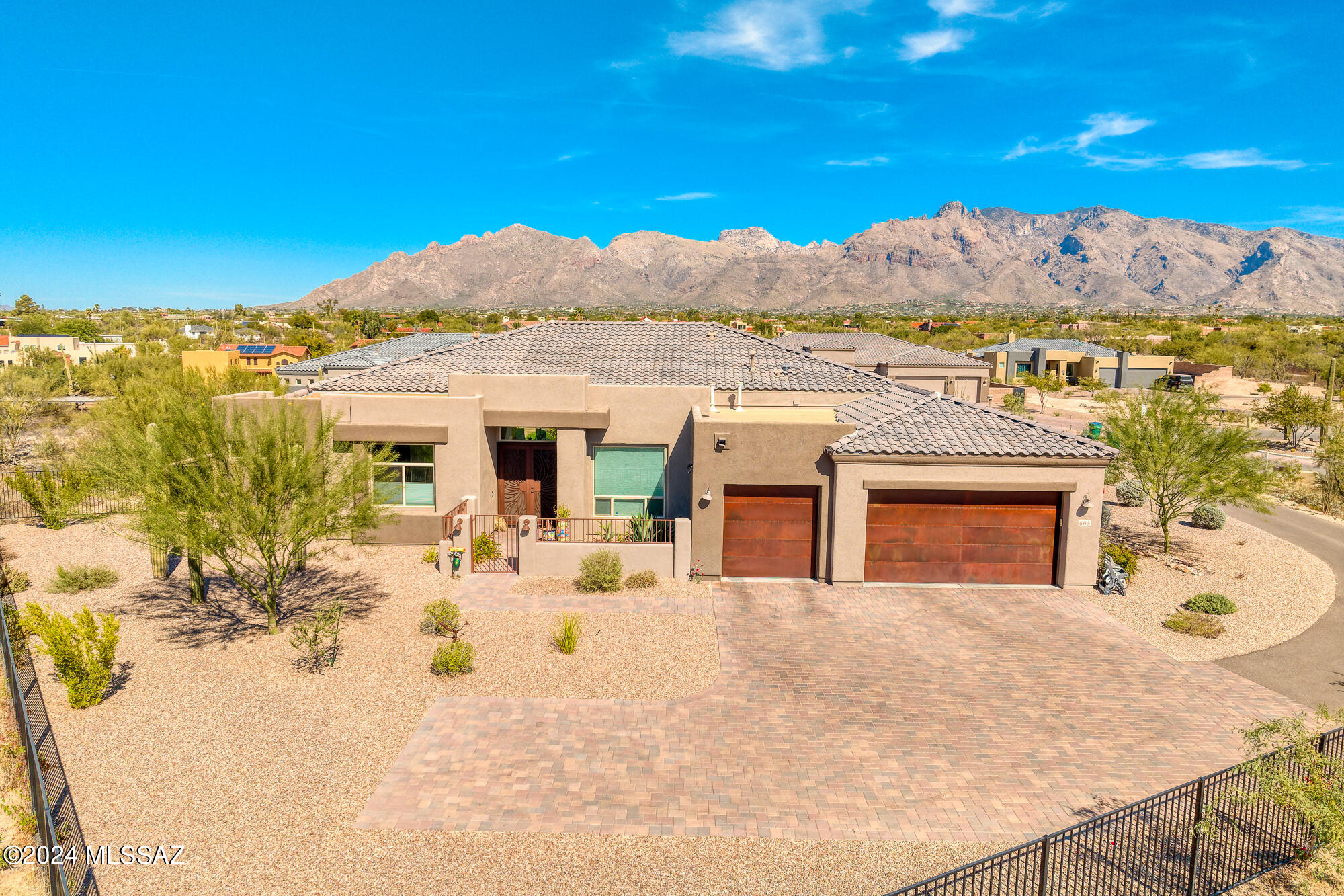 Recently built (2021) single-level home is situated in the gated community of Agave in the Foothills. The modern, open floor plan includes three spacious bedrooms, each with a walk-in closet, and a versatile family room that can easily be converted into a fourth bedroom. Each bedroom has direct access to a bathroom, and there's an additional powder room in the hallway. The kitchen boasts numerous upgrades, including an eat-in bar, extra built-in storage in the dining nook, a walk-in pantry, and more. The laundry room is well-equipped with a sink and additional cabinetry for storage. Enjoy stunning views of the Catalina Mountains from the extended covered rear patio and the large landscaped rear yard with turf, fruit trees, and apple trees, with plenty of space for a future pool. continued The 3-car garage provides ample storage, and there's a water softener included. 4th bedroom currently used as a den/family room. Seller may give credit for closet/door with an acceptable offer if Buyer requests.