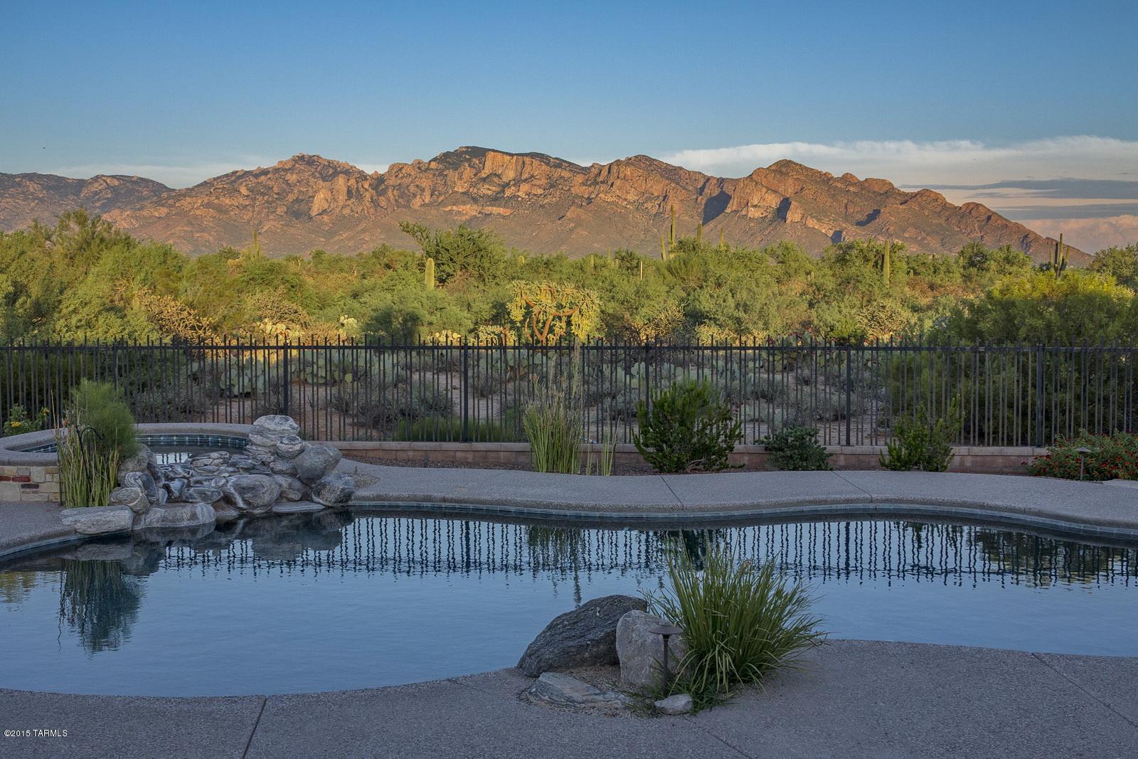 This exquisite custom home of the highest quality and craftsmanship is on 3.3 acres, affording you the ability to enjoy plenty of privacy and still have access to everything Tucson has to offer. The irresistible mountains blend into the gorgeous Sonoran Desert and will surround you with the serenity only  nature  can provide. The kitchen is a knockout  with commercial grade SS Dacor appliances, a cook’s dream with  all the bells and whistles. High ceilings, wood, high end carpet and travertine flooring, granite and quality finishes throughout. Mountain views inside from many windows. Outside you will find a fire pit, a saltwater pool, spa, beautiful landscaping,  fruit trees and a covered patio with a stone fireplace where it’s all about the stars and those views!