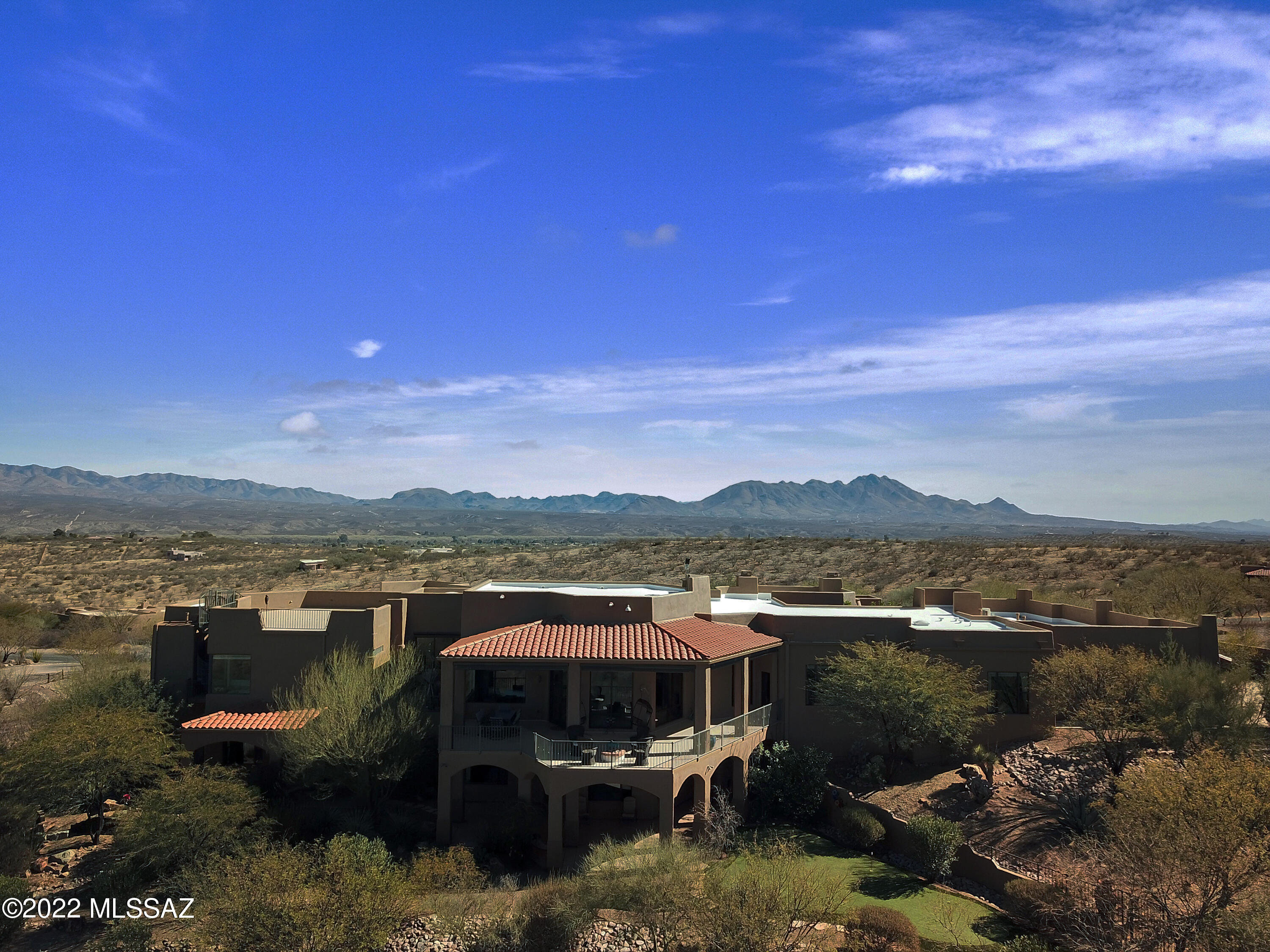 Stunning 4 BR/5 1/2 bath contemporary Santa Fe style home on 6.47 ac above the historic village of Tubac and has commanding views of eh surrounding mountains and he valley below in prestigious and private Cerro Pelon.  Designed to capture the views.  This home features an upper level with a gourmet kitchen, living room w/ large mesquite bar, family room, office and a split bedroom plan.  The lower level was designed with fun and play in mind.  A large game room with pool and foosball tables, library/media room, art studio/workout/craft room accessible by stairs or elevator, invites your family and guests down to play.  2 guest bedrooms are ensuite. All furniture and furnishings by SBOS.
