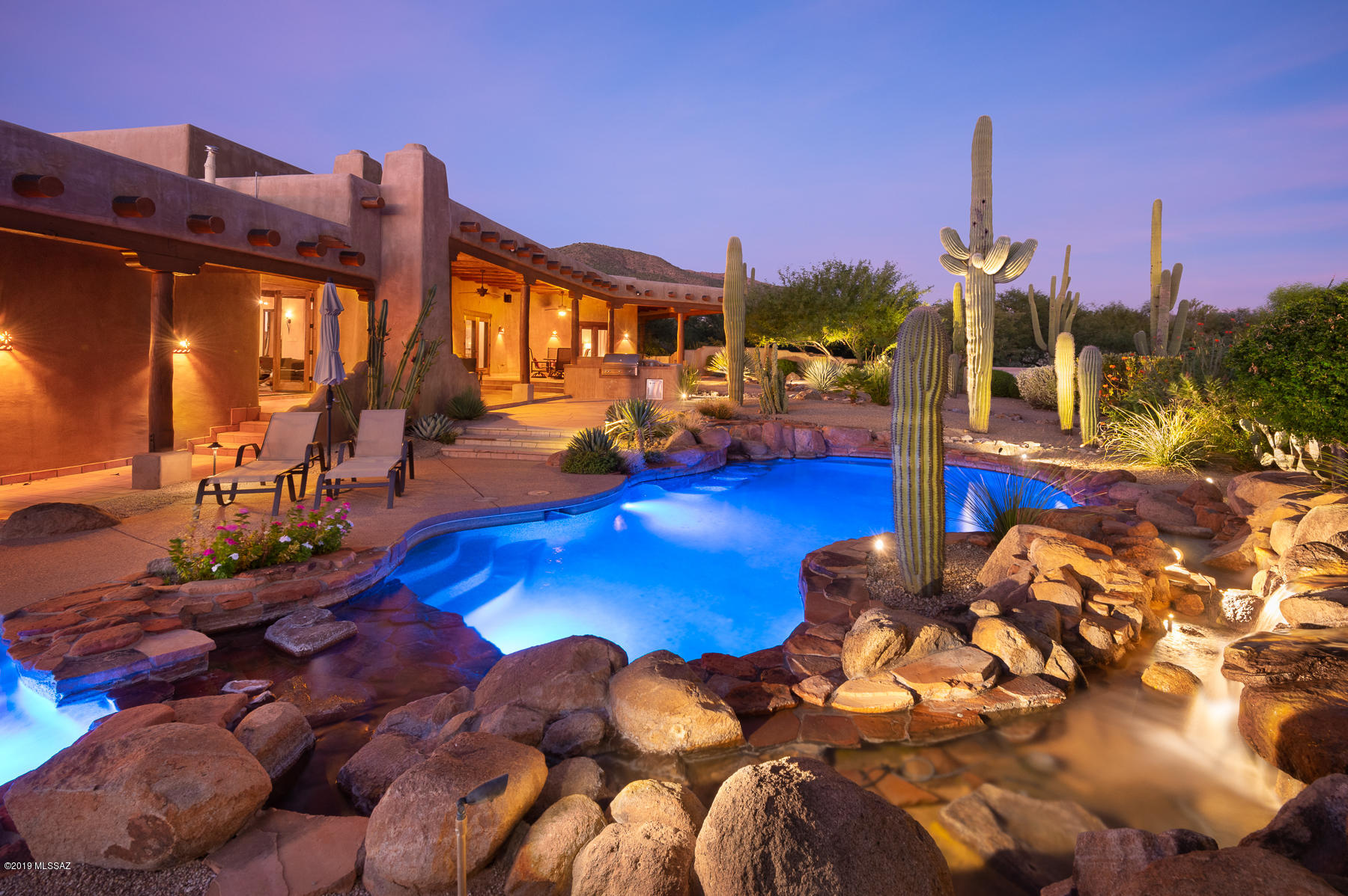 Breathtaking Catalina Mtn & sunsets views from this authentic, STUNNING Santa Fe home built by & for renowned Ray Birch in pristine gated 'The Sanctuary' (million $ homes). Incl 2 dividable lots - Lot 3 & 4. Borders 126 ac Nature Conserv. deeded County protected land adj to Sabino Canyon. Tucked in private cul-de-sac, authentic SW appointments create phenomenal indoor/outdoor living. Features: SOLAR panels, Covered beamed wrap around tiled patios, Viga beams, saguaro ribs/peeled pine & plank ceilings, Saltillo tile floors, hand troweled imperial plaster walls. Alder Int Doors, Butler front & French doors, Sub Zero/Wolf SS apps, 3 wine fridges, 4 kiva FP, private master w/  FP & jacuzzi. Pool/spa w/ cascading waterfall  42'' Lynx grill. 3 bdrms + Bonus Rm. AC in 3 car garage + wkshp.