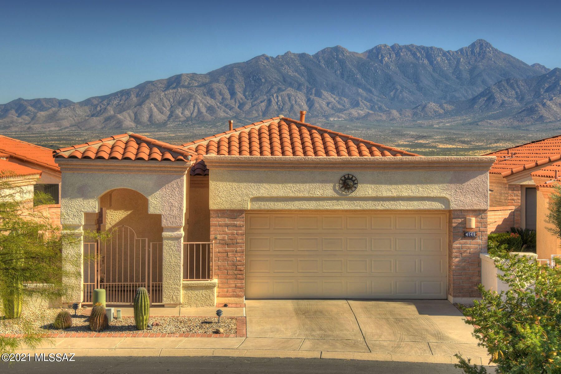 Beautiful views, beautiful home!  The Santa Ritas have never looked more stunning than they do from the back patio of this home!  You will surely spend most of your time on this bricked and covered patio, soaking up the desert sun and those amazing views!  Inside, a wall of windows along the back of the house bring those views right into your living areas.  Beautifully furnished with a modern touch, this home is ready to host your housewarming party the minute you open the door!  Fresh, neutral colors flow throughout, offering an elegant palette to showcase the lovely furnishings and decor.  The Santa Ritas are the focal point for the spacious living room and dining area.  A powder room is a convenient addition.  Spend your mornings in the bright and sunny kitchen, featuring tons of storage and pretty maple cabinets.  A bonus sun room is perfect for reviewing recipes or doing computer work.  An adjacent BBQ patio stands ready to host the next grilling event.  The primary suite has its own stunning views and a private office large enough to accommodate any hobby, or possibly a library?  Step out to that gorgeous patio through large sliders.  Two en suites ensure that your guests will be comfortable with plenty of space and a private bath.  The garage has an additional work space  for home improvement projects or simply more storage.  If "mountain views"  and "turn key" are phrases that are important to you in your desert journey, then WELCOME HOME!