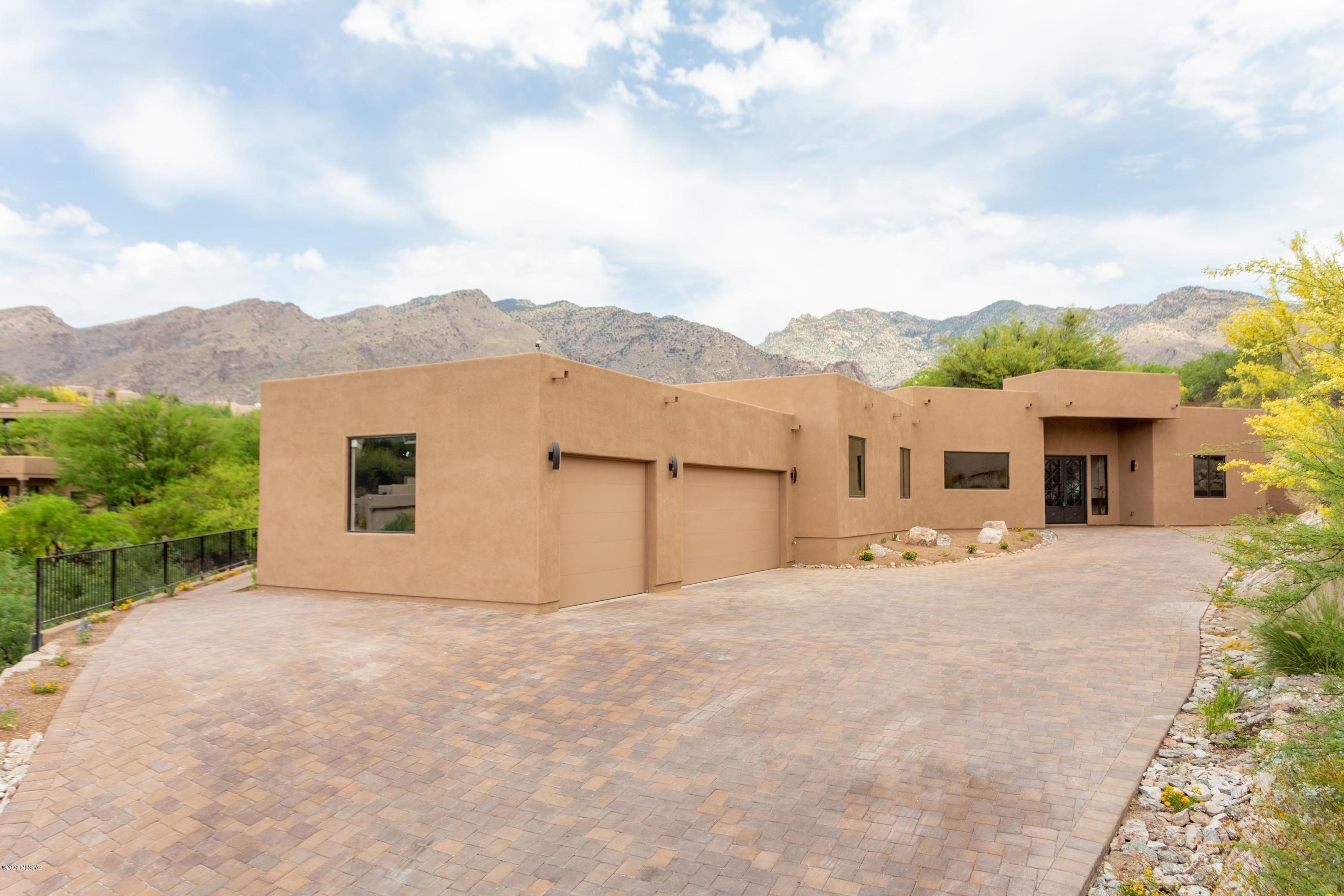 Exquisite brand new soft contemporary home w/majestic mountain views in prestigious Alta Vista. Glass & iron front entry doors, exceptional home w/over 4408 sq.ft. Light & open flr plan includes a Greatroom w/dramatic high ceilings, stunning fireplace, formal dining rm, gourmet island kit w/granite countertops, stainless steel appliances,  gas stove top, 2 dishwashers,  lg pantry, breakfast area,  gorgeous 24''x12'' porcelain flrs , Pella wood cased clad windows, 5 BR's & 5 BA's including master  w/fireplace, sitting area,  lux bath w/granite & travertine, walk in closet, priv entry to patio. Incredible bkyd w/cov'd brick  patio, pool, grass, outdoor kit w/BBQ, sink & fridge, 3 car gar, brick paver driveway, Dist.16 schools,. Seller is a licensed realtor in  Ariz. Flr plan under photos.