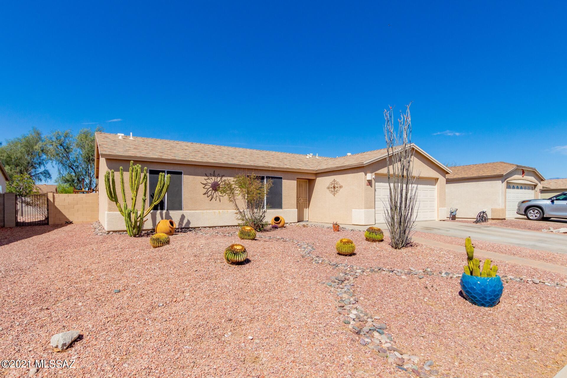Gorgeous single level home w/great curb appeal.  Sensational backyard setting w/a sparkling fenced pool, covered patio, artificial turf, & colorful plants.  Perfect outdoor entertaining space. Soaring ceilings, custom palette, upgraded ceilings, beautiful tile floors, window blinds, & patio access from the dining area. Plenty of wood kitchen cabinets, SS appliances, pantry, double sink, pet door, & lots of counter space. Generous size bedrooms, ample closets, wonderful laminate wood floors,  Do not miss out on this desert gem.