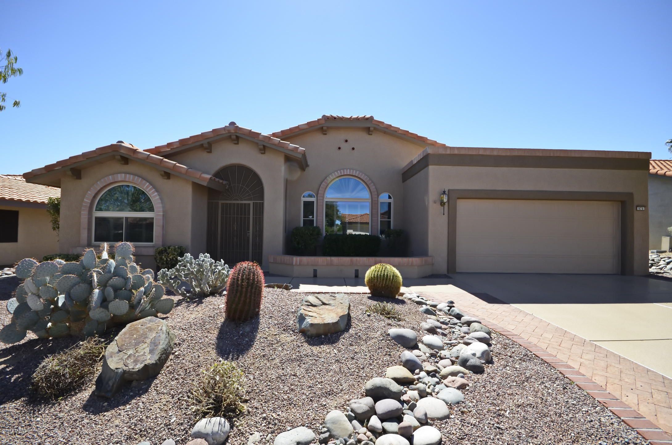 Enjoy Sun City Oro Valley's active adult community in a 2BD + Den 2,328 sqft. home. The spacious floor plan is very desirable with a formal dining room/living room combination, large bay windows, family room with gas fireplace, updated kitchen with gas stove, center prep island, desk, breakfast bar & nook. This split floor plan has two bedrooms and a large den w/ a double door entrance. The master bath includes two sinks, large soaking tub, shower & walk in closet. Additional bonuses include hardwood floors, plantation shutters, built-in bookcases, newer windows & a multi-purpose room. Appreciate the backyard oasis with Catalina mountain views, extended patio and mature landscaping. This home is move-in ready!