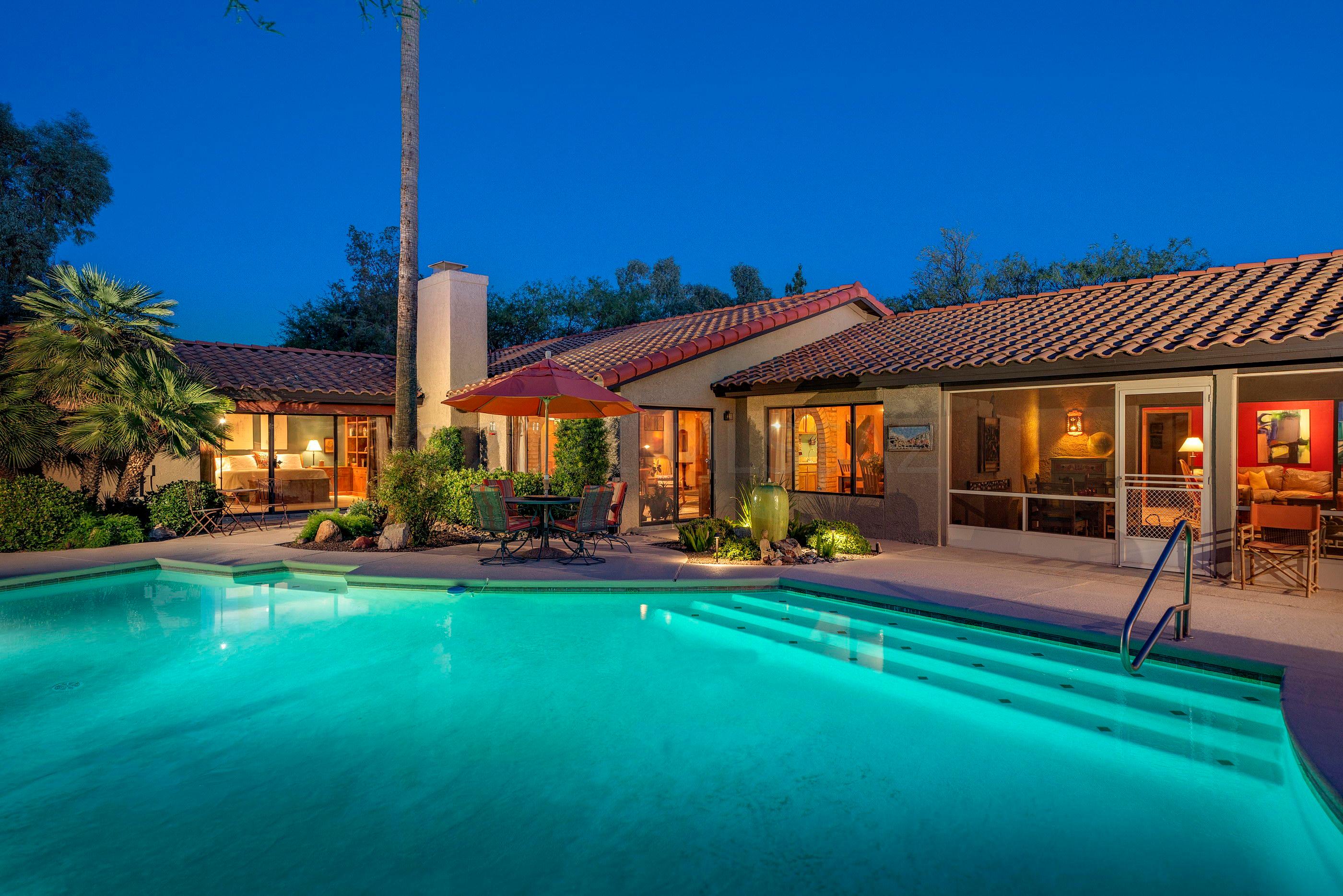 Nestled within the highly sought after gated community of Powder Horn Ranch, this stunning vernacular home possesses a refined fit and finish level felt immediately upon entry. Beyond the home's private circular drive approach, one is greeted by an open and resplendent floor plan, replete with modern accents and textures complimented by the striking Saltillo tiled floors that float seamlessly throughout the space. Exposed masonry walls, juxtaposed against the soaring wood beamed ceilings providing a visual and tactile experience, allowing natural light to filter in through an array of North facing picture windows with views that stretch out over the private and resort-like backyard. The cozy and casual living and dining spaces, opening onto the large family room and gourmet chef's kitchen, complete with stainless steel appliances, custom Alder cabinetry and extensive granite countertop space, with ample storage throughout. The owners suite is sequestered on the North end of the property, captivating it's audience with a large walk-in closet, luxuriously finished bath and sliding glass doors providing access to the rear yard and private outdoor shower. 

Perfect for family or friends alike, the secondary bedrooms are situated along the East and South ends of the residence, offering spacious rooms, with natural light and walk-in closet storage. 

The oversize backyard, features unique outdoor living opportunities, with a screened in Arizona-Room providing year round enjoyment, while overlooking the sparkling pool and outdoor kitchen, fully equipped with a built-in pizza oven and serving counter, creating the perfect framework for the Arizona lifestyle. Close to shopping, golf, fine and casual dining and world class hiking and biking trails.