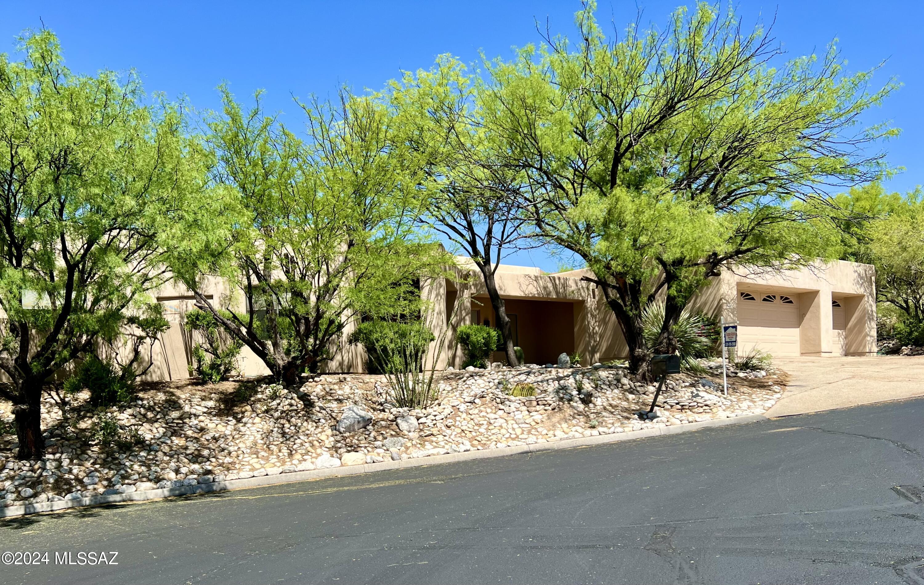 Custom Contemporary Southwestern 4 bedroom home in a very private setting at the end of the street. Relax, entertain, and enjoy nature in this spacious oasis nestled
between mature trees on a quiet cul de sac in the Catalina Foothills.
Enjoy nature, wildlife, city lights, starry skies, and mountain views
from inside and out and from the negative edge pool and in-ground spa,
and enjoy extensive xeriscaping and natural sitting areas made of
hand-fitted stone. Negative edge pool and spa off the patio. Gated Sabino Canyon area. At the end of a cul-de-sac, so lots of parking. One year home warranty provided.