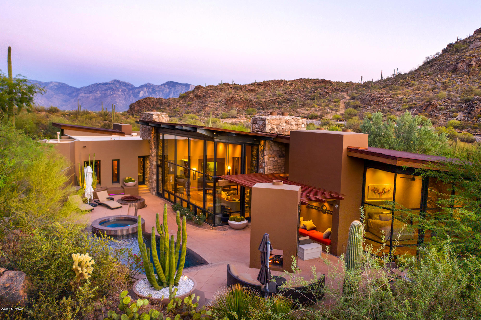 Stunning masterpiece by award winning architect Michael Franks on 9.16 acres in prestigious Saguaro Ranch, a community like no other w/one-of-a-kind entry thru mountain tunnel w/24-hour guard gate. Modern contemporary design w/exquisite earthy materials provide perfect blend of comfort & desert living. Integrated into granite hillside, the vertical structure emerges as part of surrounding terrain & precisely relates to adjacent rock outcroppings as an extension of the architecture. Spectacular Mountain & Sunset views, stunning 4,721sf home w/2 master suites w/private patios+670sf 1BR/1BA casita. Magnificent wall of windows faces private saguaro-studded hillside. Several patios & outside living spaces enhance pristine desert living experience w/Zen water feature, putting green, pool/spa. A sanctuary blessed with the grandeur of the desert southwest, Saguaro Ranch is a prestigious real estate community whose location in the Tortolita Mountains just north of Tucson is as majestic as it is serene. Distinguished by a one-of-a-kind tunnel entrance and National Park like setting, it combines welcomed privacy with an active, outdoor lifestyle and diversity of amenities.

Optional (not included in the HOA)Saguaro Ranch Owners Club $4,000 initiation fee& $275/month. Saguaro Ranch Owners Clubhouse pool complex including the main pool, spa and swim up bar area excavation, molding and utility trenching are almost complete and feature some gorgeous exterior pool stone work by Martin Rockworks.