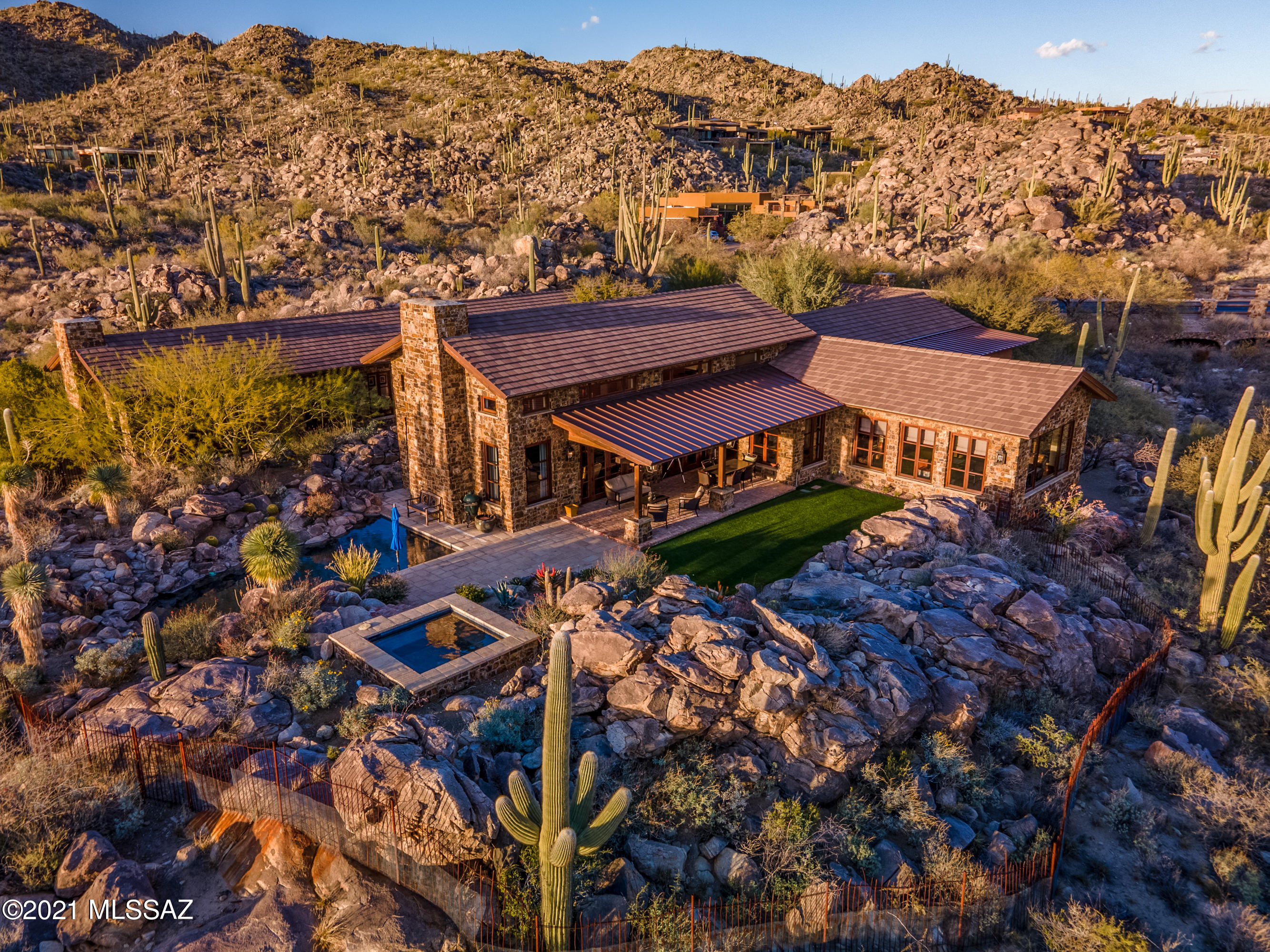 Rock Solid - Featured in Luxe Magazine - McHallam Construction and Ron Robinette came together and built a one of a kind Fortress. Masonry constructed with 2x4 fur out along with real stone veneer made for massive thick walls. Intergral colored 3 coat cementatious stucco, pitched roof with concrete tile and standing seam metal roofing leaving no flat roof to be found. Double layered sound proof between bedrooms, laundry and study, wire brushed cedar french casement windows, 3 true masonry chimney wood burning fireplaces, exposed re-sawn fir beams and tongue and groove ceilings, walnut wood  & antique  french limestone flooring, custom hand painted (Farrow and Ball) cabinetry. Wide open spaces in your dream kitchen looking out into great room and dinning.  Marble, Limestone and soapstone countertop surfaces, Hans Grohe plumbing fixtures, Urban Electric lighting fixtures and Jean De Merry to name a few of the high end quality finishes that went into this beautiful home.  Lutron Lighting controls, low voltage recessed lighting throughout with built-in surround sound.  Master Bedroom and Bathroom beautifully done with separate vanities -  TV Mirror at vanity - Separate tub and steam shower - fireplace beautifully faced with antique french limestone. Backyard features salt water pool, water feature and raised spa nicely tucked into the rock outcroppings for maximum views and privacy.  Membership required to the Stone Canyon Club. Tour of this home and development amenities can be scheduled 7 days a week. Stone Canyon continuously ranks among the top Golf Clubs in the country.