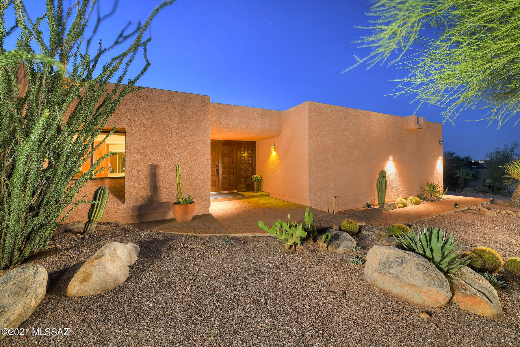 This single story, modern ranch home sits on just short of an acre, in the exclusive Sin Vacas neighborhood! This entertainer's dream home features 2,450 square feet of living space with 3 bedrooms, 2 bathrooms, and an office. Enjoy tons of natural light throughout the amazing floor plan with raised ceilings, multiple skylights, and walls of windows and French doors. Parking is spacious with an oversized 2 car garage and a separate RV garage. The kitchen features an electric range with hood,stainless steel refrigerator, and dishwasher.  The kitchen opens to one of the most beautiful views of the Catalinas Tucson can offer. This home also offers a living room and dining area with a wet bar that is perfect for intimate family gatherings or large celebrations. The large primary bedroom has a walk-in closet and can accommodate a cozy sitting area with direct access to the beautiful backyard and outdoor shower. The large, super-private backyard is a true oasis and features a covered patio, and pool with a breathtaking view of the Catalinas. If you enjoy the sunrise, the sunset or both, this home has the spot for you.  As a plus, you would be the 2nd owner of the meticulously cared for home. Simply move in and create new memories! You're only minutes away from entertainment, restaurants and shopping at Tucson's very own La Encantada shopping center. Hurry this home will not last!