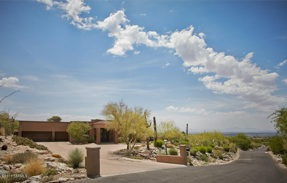STUNNING ONE-LEVEL CUSTOM HOME WITH DRAMATIC CITY LIGHTS AND MOUNTAIN VIEWS NESTLED HIGH IN THE CATALINA FOOTHILLS PRIVATELY SITUATED ON THE 12TH HOLE IN GATED SKYLINE COUNTRY CLUB. BEAUTIFULLY APPOINTED LIVING AND DINING ROOMS, GOURMET KITCHEN, FAMILY ROOM, MASTER SUITE OVERLOOKS SPACIOUS COVERED PATIO,POOL AND JAW DROPPING CITY VIEWS. OPEN AND FLOWING FLOOR PLAN OFFERS 5 BEDROOM SUITES, MEDIA ROOM, BUTLER'S KITCHEN, WALK-IN PANTRY, EXERCISE ROOM, WINE ROOM, OUTDOOR SHOWER. THREE CAR GARAGE WITH ELECTRIC VEHICLE CHARGER AND GOLF COURSE ACCESS FOR WALKING. 20 MINUTES TO UMC AND UA. GREAT OPPORTUNITY TO OWN ONE OF THE MOST EXCLUSIVE LOTS IN SKYLINE.