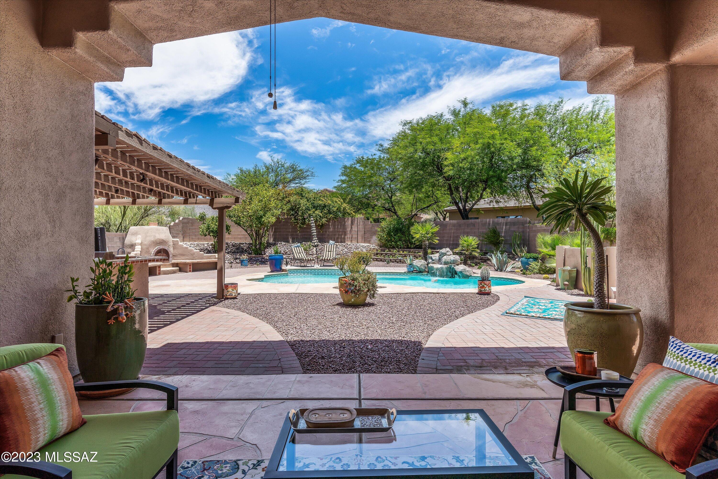 Fabulous home in Dove Mountain nicely situated on a cul-de-sac lot. Open concept split floorplan w/great room that opens to kitchen and dining room. The kitchen features stainless steel appliances, granite counters, and plenty of cabinet space. Spacious primary suite features 2 closets, tub & shower & sliding door that opens to the back patio. Guests will enjoy the privacy of the generous sized guest suite w/attached sitting area. Step outback to discover the beautifully landscaped outdoor oasis! Waterfall pool, hot tub, fireplace & covered ramada w/outdoor kitchen & built-in BBQ w/bar seating, a tiered garden with flowering plantings and even a peak at the Catalina mountains. Garage offers a sink with built-in cabinets and storage racks. All furniture available on separate Bill of Sale.