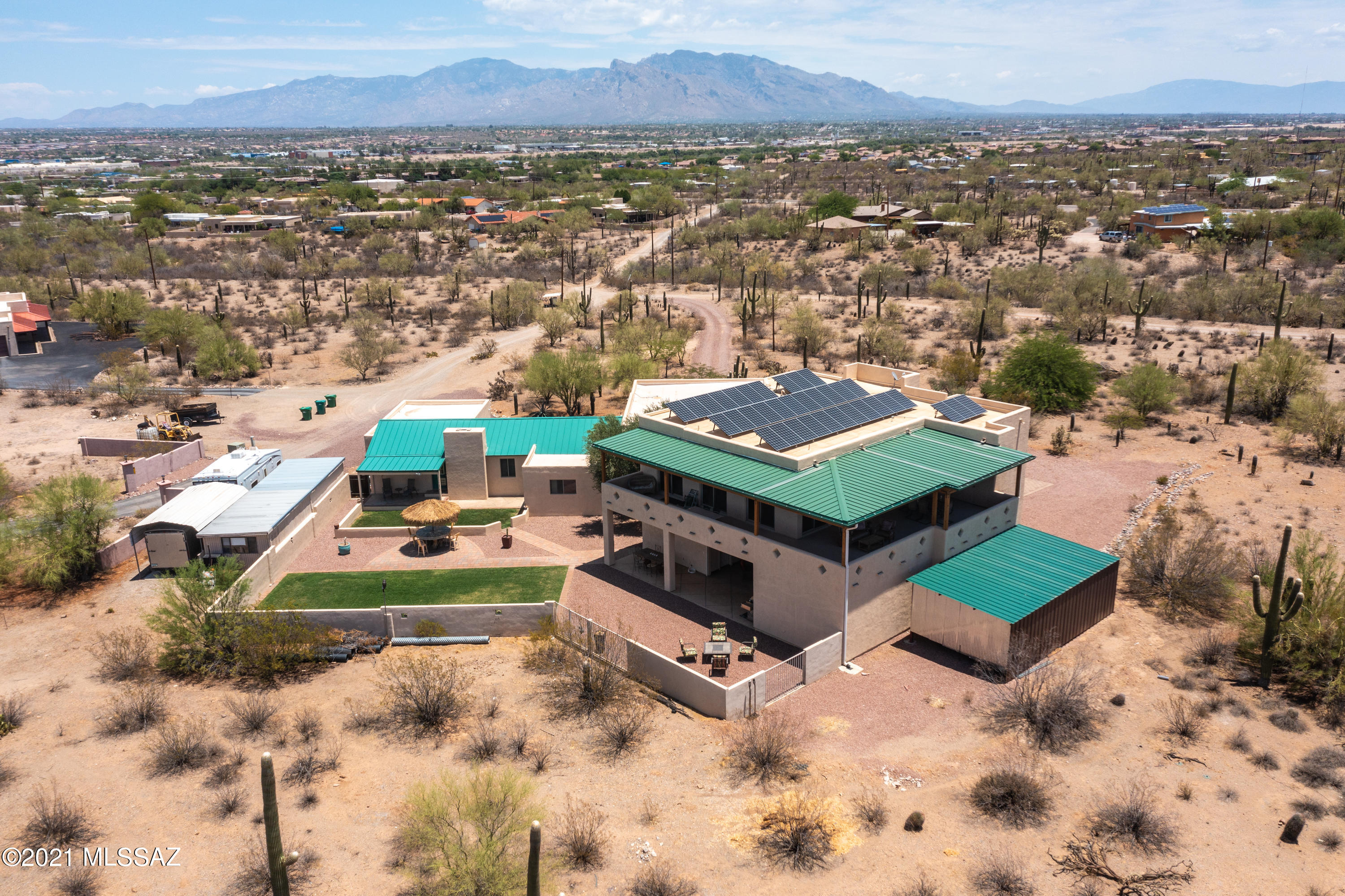 A fabulous home and guest house compound on 3.3 acres. Spectacular loft area - an entertainers premium set-up. Electronic exterior rolling shutters.  Fully owned solar system. Unique  one year old high efficiency hybrid water heater with recycling pump. R-60 insulation in roof, R-20 on walls, all interior walls insulated for sound reduction.  Guest house was renovated 14 years ago with new waterlines, electric upgrade, windows, sheet rock, sewer line under house and new roof. Guest house has its own septic.  Abundant extra garage storage in all garages - some w/AC.  Whole house speaker system.  Exterior framing completely sheeted with OSB for extra strength. Unique silicone roof on main house with solar panel.  Elevator in home.  All copper piping oversized for better water volume. No HOA. No showings until January 7th, 2022.
