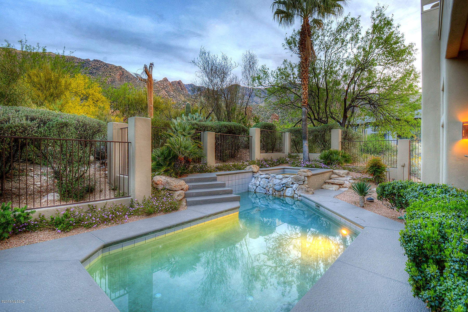Your private desert retreat awaits you behind the gates of prestigious Finisterra.  Capturing breathtaking mountain views and sparkling city lights, casual elegance abounds in this custom home. Designed and built by Brian Martinovich using exceptional craftsmanship and the finest building  materials, including flagstone and hardwood floors, solid alder doors, slate finishes and a Venetian plaster fireplace.   Enviable kitchen has a generous island with a stainless steel countertop, double drawer Fisher Paykel dishwasher, double Miele ovens, 5 burner Wolf cooktop, and a warming drawer.  Also features a Butler's Pantry with additional dishwasher and wine refrigerator.  Perfect for entertaining, with a versatile rec/game room and multiple living areas both inside and outside the home.
