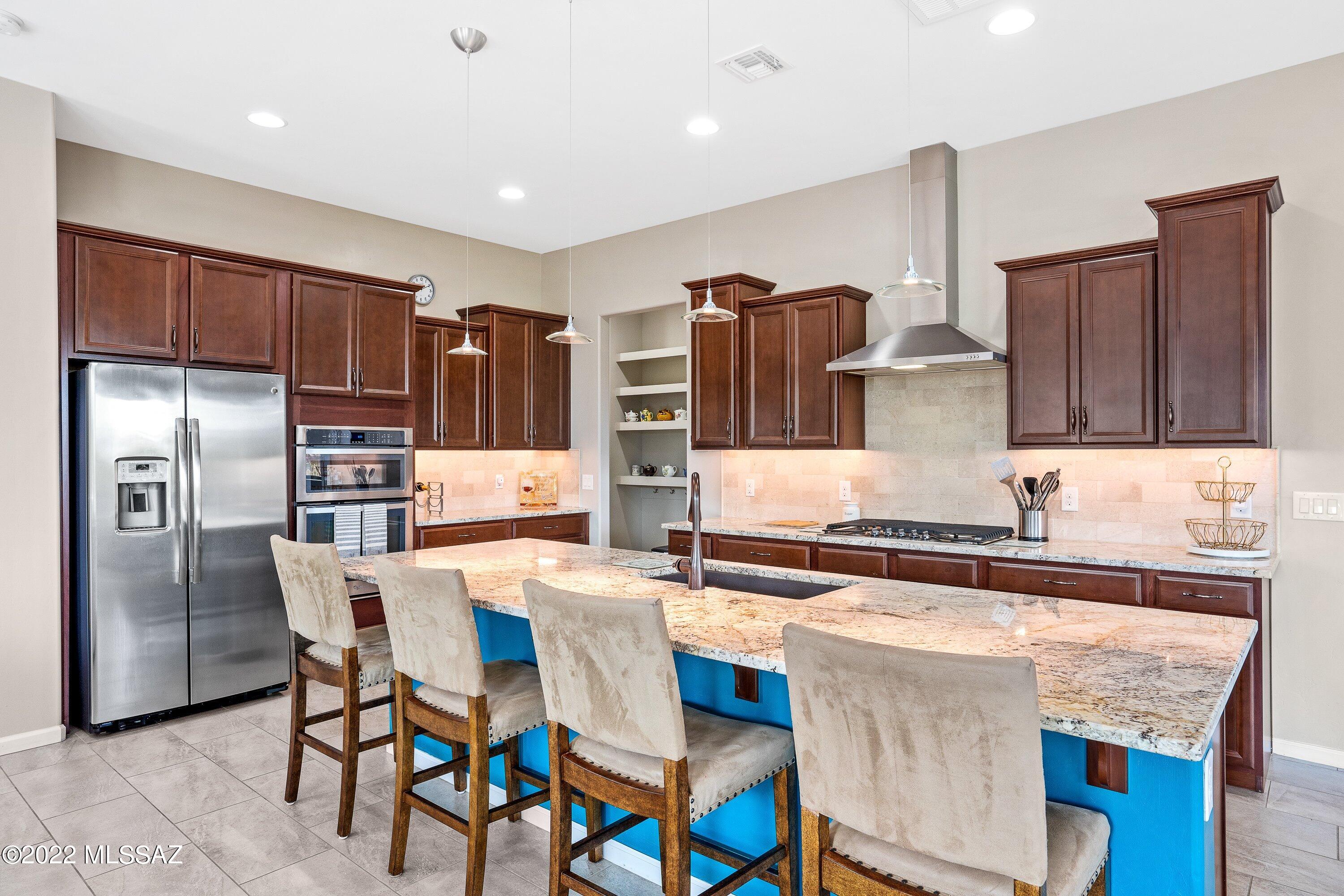 MOUNTAIN VIEWS!! Turn key 2 bedroom, 2 bathroom plus large den with french doors in desired gated Ridgeview Vistoso Trails community! Amazing mountain views on this premium end unit with only one connected neighbor. Open floorplan and countless upgrades!! The gourmet kitchen is complete with custom cabinets, granite counters, an extended island, granite sink, stainless built-in appliances, and a walk-in pantry. French doors lead into the den which could be an office or additional room. Spacious owner's suite with spa-like bathroom complete with walk-in shower, dual sinks & huge walk-in closet. Covered front patio with beautiful custom iron door and covered back patio with two ceiling fans and a connected gas grill. Tranquil water fountain as you enjoy the sunsets!