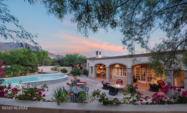 Exquisite, meticulously maintained Michael Franks designed masonry home located on an elevated, corner lot w/ exceptional views in Cobblestone, the coveted guard-gated community at the top of Campbell Ave. Sprawling single story 5 bdrm/ 7 ba home w/ lush vegetation & N/S exposure provides up-close mtn views from the resort-style backyard & the ultimate in city views from the expansive south terrace.  Charming courtyard entry w/ one of a kind fountain.  Grand foyer w/ adjacent den/library.  Expertly designed split bdrm floor plan that includes 4 en-suite bdrms, & impressive master suite w/ FP, steam shower, separate tub, dbl vanities & huge closet.  Formal living & dining room designed for large scale entertaining flow to south terrace w/ captivating views of the valley below. Gourmet kitchen w/ center island w/ prep sink & breakfast bar, 2 dishwashers, Wolf gas range, Sub-Zero refrigerator, Sub-Zero Freezer, large walk-in pantry & built-in breakfast nook. Family room w/ FP off kitchen has wet bar & walk-in wine cellar w/ commercial grade temperature control system. Deep covered patio lined w/ pavers off of kitchen w/ outdoor kitchen area has built-in BBQ, hood vent, sink & built-in bistro height buffet table. Effortless indoor/outdoor living with  immaculate backyard w/ pool, spa, gas firepit, breathtaking mountain views & lush vegetation.  Large laundry room w/ sink & plenty of storage.  5th en-suite bedroom currently set up as exercise room.  Oversized 3- car garage. Plenty of extra storage. Rare opportunity to own a premium lot in one of Tucson's most desirable communities. Homesites like this are simply no longer available in the area. Conveniently located in the center of the foothills just minutes to La Encantada Mall, top restaurants, world-class golf resorts, the University of Arizona and much more.