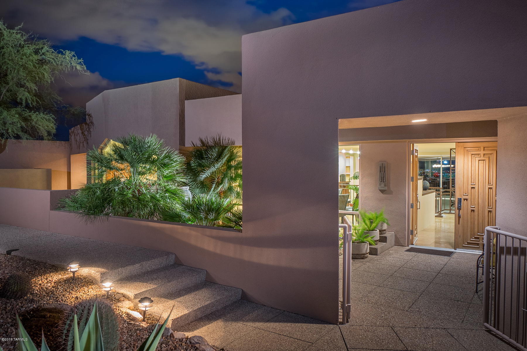 Seller will accept or counter offers between $875,000 and $950,000. Amazing Tucson Valley Lights are Viewed from this beautiful Contemporary Sleek-Style Finisterra home. Mountain Views from Kitchen & EnSuite Bedroom/Office. Gourmet kitchen w/cherry cabinets, granite countertops, top of the line stainless steel appliances, coffee bar built-in hutch in breakfast dining room, and cozy patio with mountain view off kitchen dining room. This home is like two homes in one, perfect for a multi-generational family. Guest wing quarters has two bedrooms & two baths, a great room all on one level. Attached to main residence, passing through a common wall interior door. Wall is highly-insulated for sound and privacy. Used as teen living space or perfect as a mother-in-law apartment. Easy access to water and electric to possibly add a kitchenette area in great room