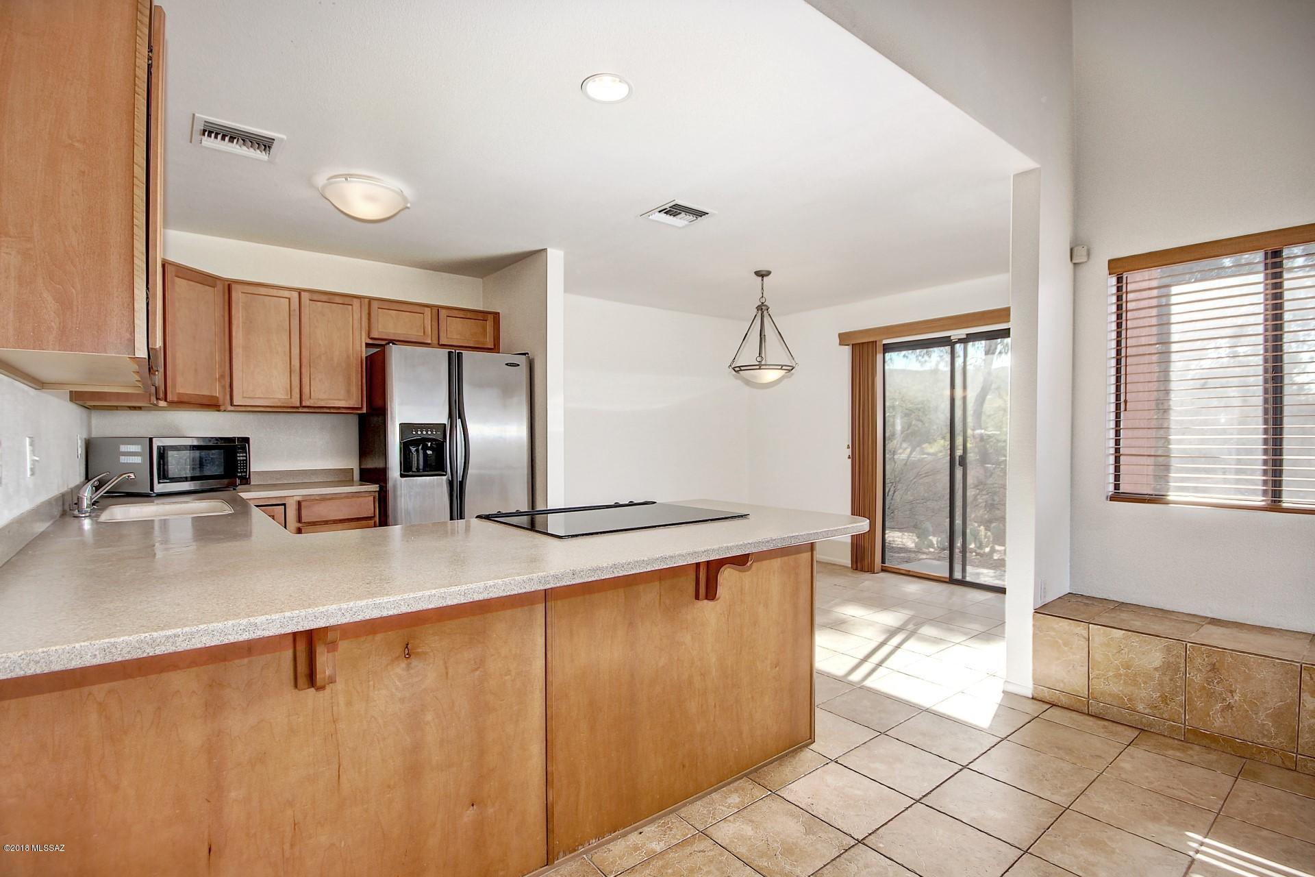 Incredible condo available in highly sought after Ventana Vista! This private corner unit allows maximum privacy with open space behind & amazing unobstructed views from all windows & large balcony. Move in ready with brand new carpet & paint throughout plus all appliances included! Spacious 2Br plus loft with closet (could be 3rd Br) in gated community in the Santa Catalina Mtn foothills. Resort style HOA - heated pool & 2 spas, tennis court, exercise facility, clubhouse with library, pool table, bbq area & more. Surrounded by world class resorts and spas & 1 mile from Sabino Canyon Park. Interior features include wood burning fireplace, energy efficient 30-gal hot water heater, ceramic tile flooring, maple cabs with executive height dual vanity, upgraded light fixtures & alarm prewire.