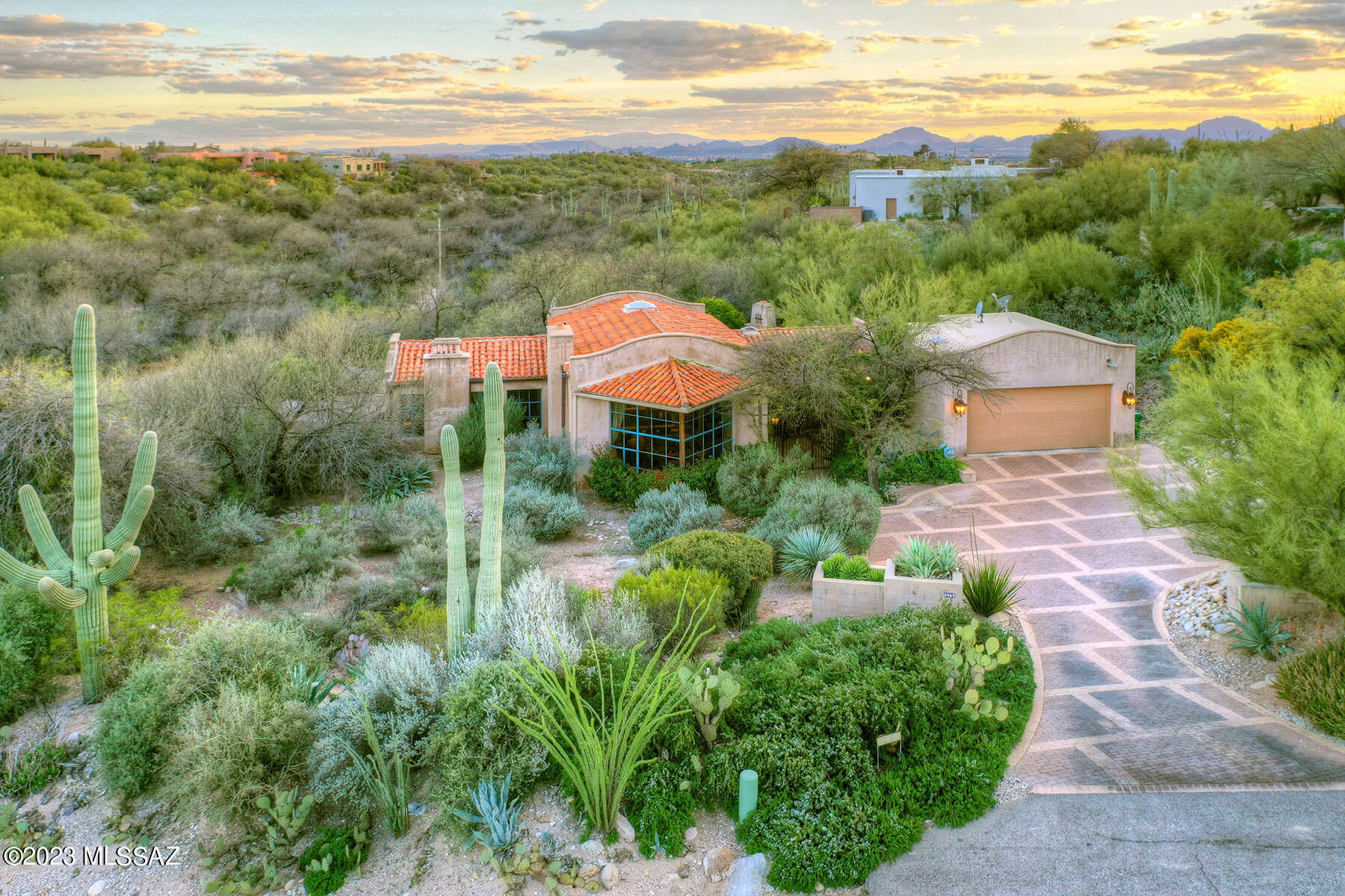 An absolute GEM privately tucked away in the middle of the prime Catalina Foothills, masonry construction crafted of the finest natural materials by Michael Franks & loaded with more charm that even the photos can show! Enter the private gated courtyard into the great room with soaring wood beamed ceilings & stunning mountain views from massive windows, fireplaces in the great room & romantic primary suite, split plan, entertainer's kitchen w/premium finishes, 2 guest rooms, HIGH SPEED INTERNET (rare for this part of the foothills), & wait until you see the back yard!  Outdoor dining rm, another f/p, ez care turf, mature trees & city views! No wasted space & plans for guest hse and/or expansion available.  One of our most favorite properties EVER! See list of add'l improvements in Document