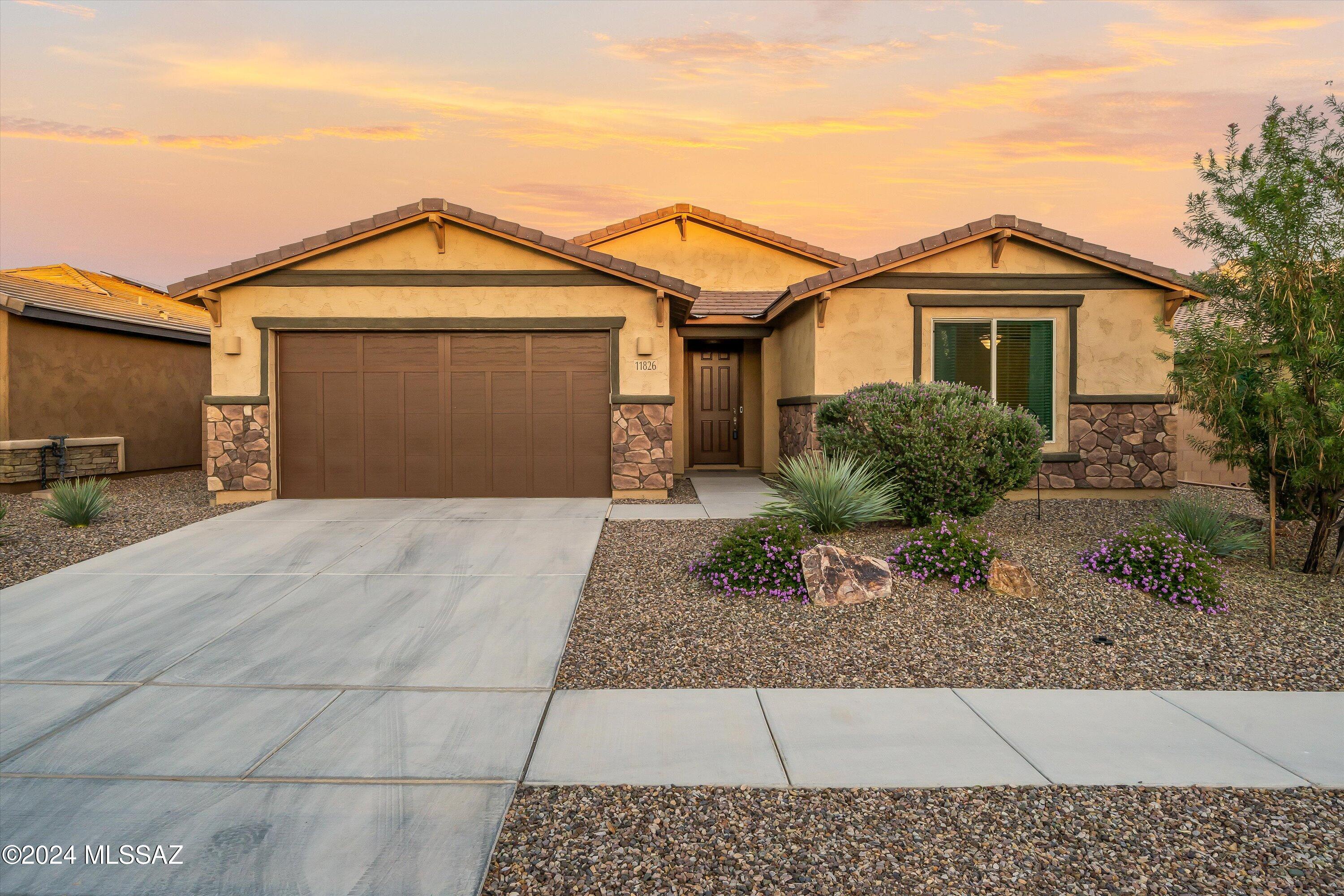 Million dollar views from the backyard of this beautiful Oro Valley home. Drive into the gated community to unwind & take in the spectacular mountains. Built in 2020, this 3 bedroom, 2 1/2 bath will not disappoint. Step through the foyer into a great room adjacent to a gorgeous kitchen complete with floor to ceiling cabinets, beautiful ceramic tile backsplash, large granite island with pendant lighting & breakfast bar. A large pantry, mud room, & laundry room with a utility sink are sure to please. Secondary bedrooms both feature walk-in closets & have a dual vanity bathroom. The primary suite is a lovely respite & features a large walk-in shower & closet. Enjoy the serene backyard setting with a pristine pool & firepit. Unwind in the majestic panorama of the Catalinas.