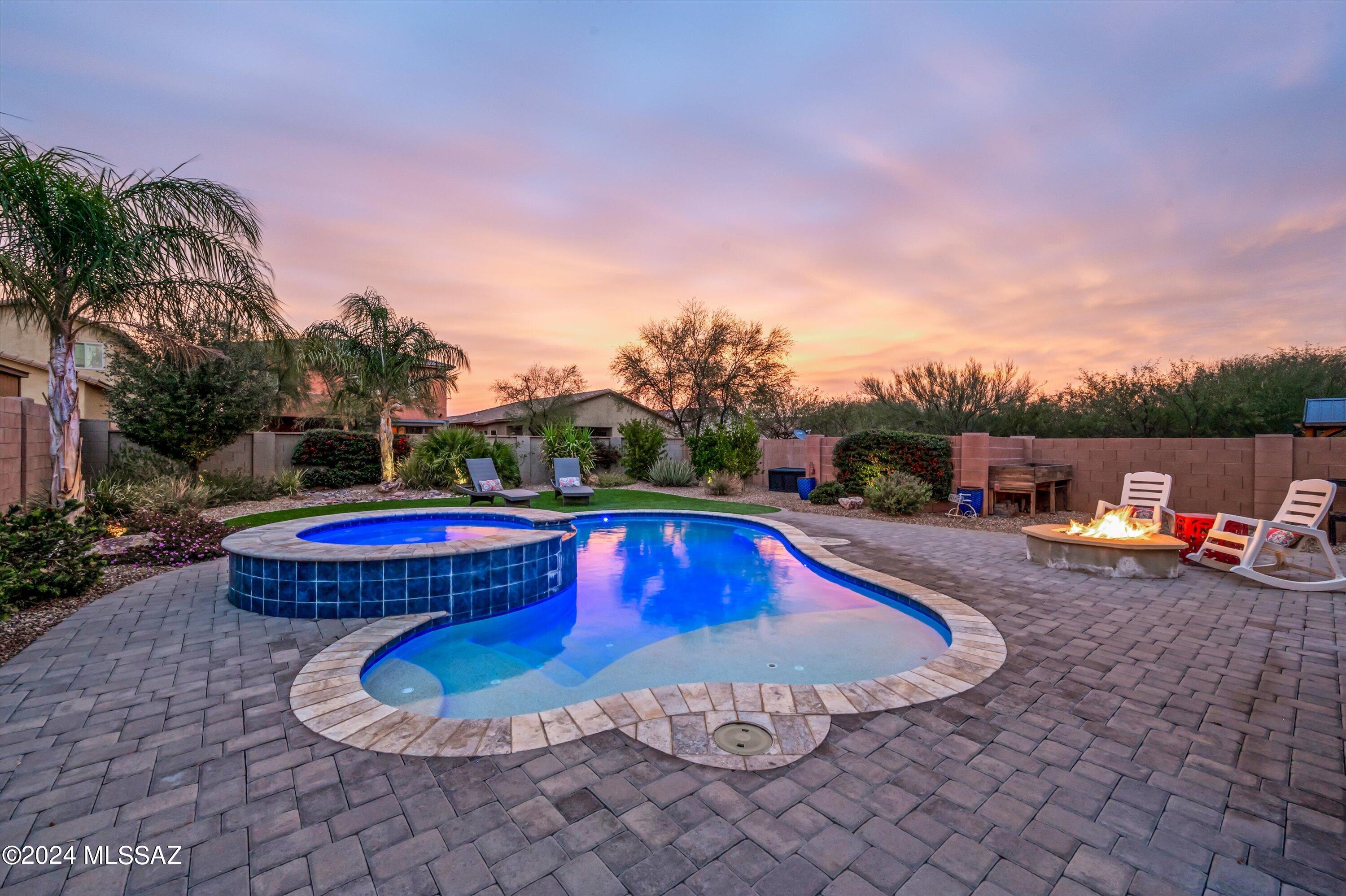 Your very own backyard oasis awaits! This single-story home built in 2018 sits on an extended lot and features 2k sqft of home containing 3beds, 2baths, and a multi-purpose den/office space suitable for any need. You will find a seamless open-concept living space with a beautiful kitchen including quartz counter tops, espresso colored cabinetry, and a large island overseeing the dining area and generously sized living room. The master bedroom ensuite features ample space to create a peaceful retreat, featuring a large walk-in closet, dual vanity sink, and separate tub and shower. Outside is where you'll find the true gem with a backyard set for year-round fun featuring a sparkling pebble tech pool + spa with solar heating and LED lighting, a gas fire fit, brick pavers, artificial turf, and mature plants throughout. It is perfect for entertaining, or for creating your very own private oasis.  

This home is right on the border of Green Valley and Sahuarita, conveniently located near shopping centers, restaurants, parks, and just minutes from the I-19 freeway. This home will not last long, some come take a look before it's gone!