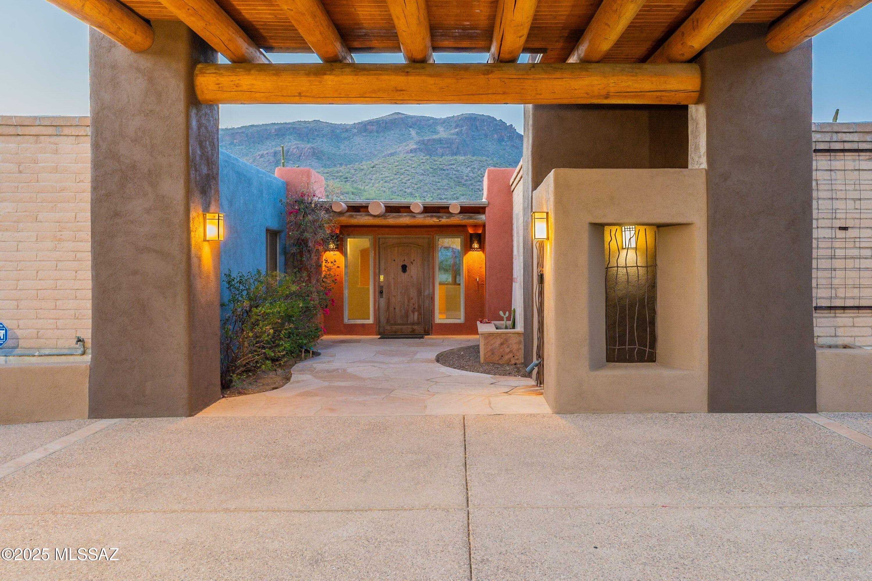 Solid construction that offers a blend of privacy, space, and beauty. Enjoy unobstructed mountain views complemented by a touch of twinkling city lights. The gourmet kitchen is a chef's dream, blending luxury and functionality with breathtaking views.  The kitchen is perfect for entertainment with top-of-the-line appliances including a Sub-Zero refrigerator and additional fridge drawers for extra convenience. The back yard is a  private oasis with a backdrop of the beauty of the desert designed for both relaxation and entertaining, huge deep pool perfect for cooling off this summer. Covered patio with rustic vigas, built-in BBQ grill and sink. Stunning mountain with natural desert landscape that blends seamlessly with the surroundings, creating a peaceful and picturesque retreat.