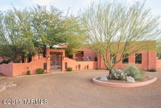 Enjoy sumptuous surroundings in this splendid, custom home located in the desirable Madera Shadows Neighborhood.  A private setback from the road offers privacy and impressive sweeping views of the desert valley and a magnificent vista of the Santa Rita Mountains.  Located on 2.36 acres, this 3,739-square foot home including a 602 sq.ft. guest house is completely custom from the ground up.
Situated to enjoy breathtaking views from inside and out.  Bask in the sun from your patio or luxuriate by the pool or in the hot tub.  Entertain friends and barbeque from your outdoor kitchenette while watching another smashing sunset.  The open living areas boast large windows framing stately views from nearly every room.