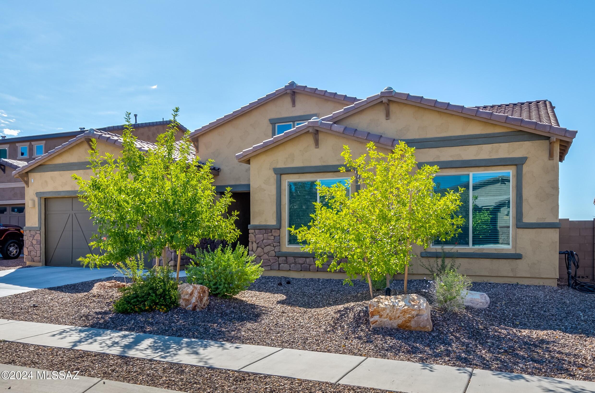 Built-in 2022, this 3,241sf single story home w/5BR/3BA+den sits on a premium view lot in the gated Villages at Silverhawke in Oro Valley with incredible Pusch Ridge & Catalina Mountain Views. Open floor plan offers endless possibilities to make this home uniquely yours. The gourmet kitchen has stainless appliances, quartz counters, 5-burner gas cook top, ample cabinetry w/under cabinet lighting, pantry, casual dining area & generous island w/single basin sink that overlooks the great room & dining area w/bar seating & pendant lighting above perfect for family gatherings and entertaining. Great room has a triple collapsable sliding glass door allowing the views to pour in & seamlessly blends indoor & outdoor space. Other features include cordless wood blinds, ceramic plank flooring, & back yard wrought iron view fencing. With 4 secondary bedrooms, pocket office off kitchen & den there's plenty of space to spread out. The primary suite features split vanities, a soaking tub, separate shower & large walk-in closet. 2 car garage w/4' extension. The community features 4 neighborhood parks & nearby amenities such as top-rated schools, hiking trails, biking paths, convenient access to shopping, dining, medical services, entertainment, Chuck Huckleberry Loop, Oro Valley Marketplace & Catalina State Park, making this location perfect for both relaxation and outdoor activities.