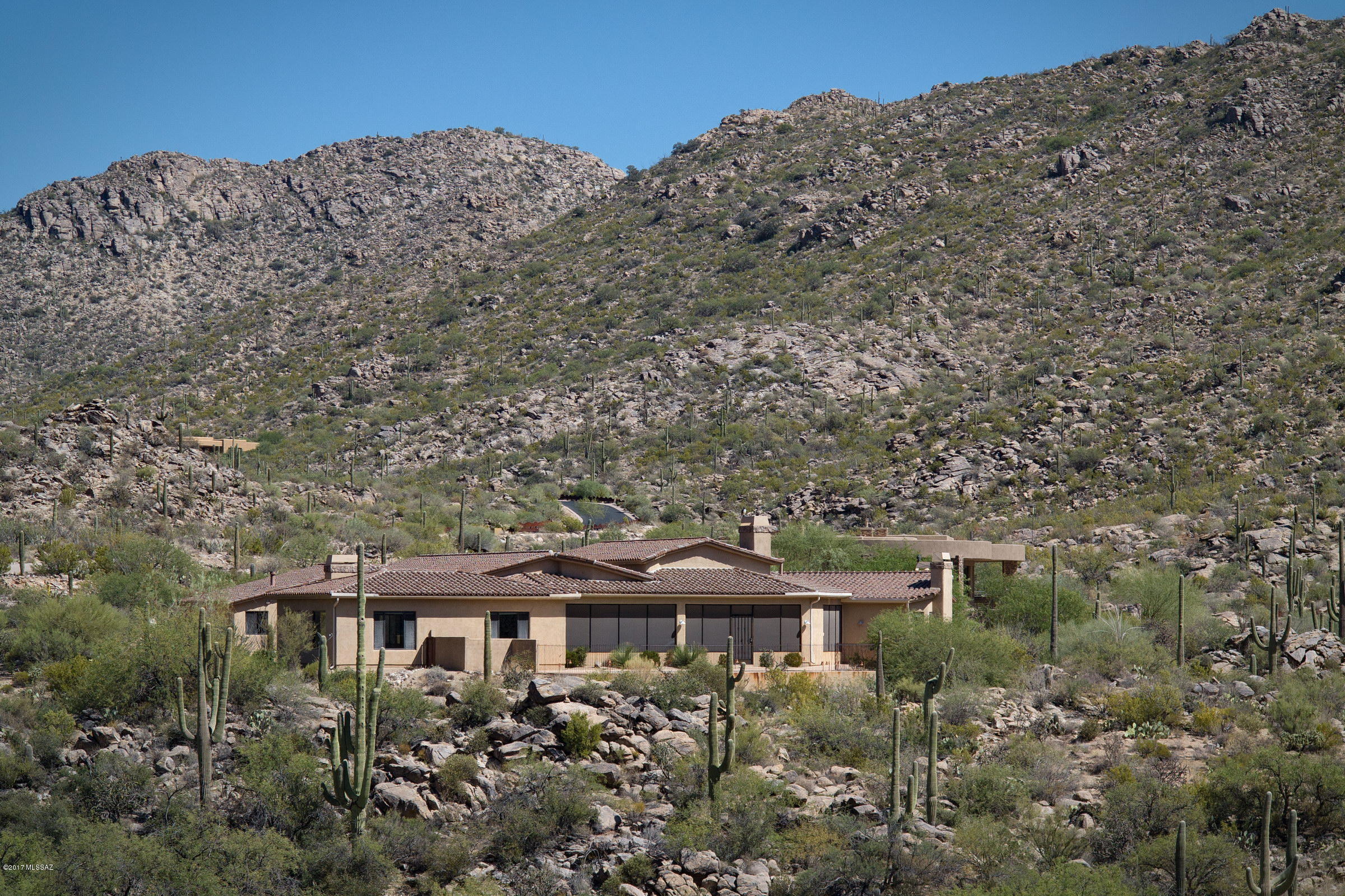 HUGE PRICE REDUCTION AND BEST VALUE IN CANYON PASS!!! SITUATED ON A PREMIUM VIEW LOT, W/ PANORAMIC VIEWS OF THE NATURAL DESERT, MTN VISTAS & VALLEY LIGHTS BEYOND. THIS 5,143 SQ FT SPECTACULAR ESTATE W/988 SQ FT BONUS ROOM, SITS ON 2.03 SPRAWLING ACRES IN THE EXCLUSIVE GUARD GATED CANYON PASS AT DOVE MOUNTAIN COMMUNITY NEAR THE GALLERY GOLF CLUB AND THE RITZ CARLTON RESORT. THIS CUSTOM HOME FEATURES HAND SCRAPED AMISH HICKORY WOOD & TRAVERTINE FLOORING, CEILING BEAMS W/ CUSTOM MOLDING DETAILS, PELLA WINDOWS. THE CHEF'S KITCHEN OFFERS GAGGENAU DOUBLE OVENS W/ WARMING DRAWER, VIKING RANGE, VIKING REFRIG/FREEZER, 2 DISHWASHERS, MAIN & PREP SINKS, GRANITE CNTRS & ALDER CABINETS. MSTR HAS TWO HUGE HIS/HERS WALK-INS CLOSETS. ALSO FEATURED IS THE OVERSIZED 5 CAR HEATED/COOLED GARAGE W/ WORKSHOP THE ELEVATED COVERED PATIO CREATES THE FRAMEWORK FOR THE  POOL & SPA, ACTING AS THE PERFECT CENTERPIECE OF THE OUTDOOR LIVING & ENTERTAINING SPACE.
