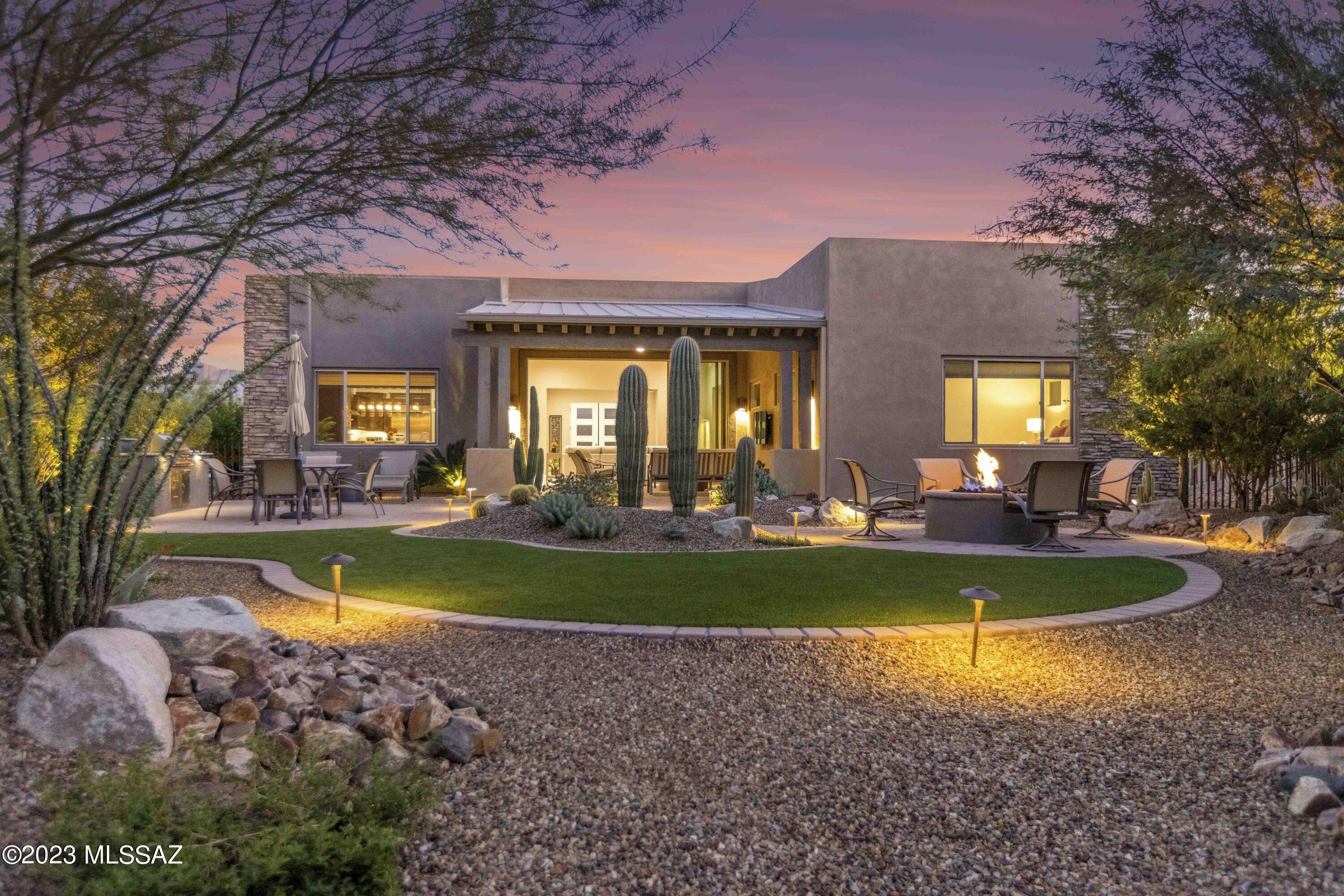 Experience the pinnacle of luxurious living in this Enclave home tucked inside the gates of the exclusive Stone Canyon community, home to one of Arizona's premier golf courses and cutting-edge health & fitness centers. 
This meticulously maintained residence features an open floor plan, adorned with 12' ceilings and a 10'x 16' sliding glass door, seamlessly merging the ideal setting for indoor/ outdoor living. The kitchen features a large entertaining island, SS appliances, ample cabinet space and a separate dining area.  
Convenient split floor plan that includes a generous primary retreat with double vanity, walk-in shower, and a custom-designed California closet.  The guest bedroom provides  privacy with its exclusive en-suite and the expansive den/office that can effortlessly accommodate a Murphy bed.  
Experience the perfection of a professionally designed, impeccably landscaped backyard featuring 3 distinct patio areas perfect for year round entertainment.  Gather friends for a BBQ and savor tranquility with a glass of wine by the fire pit. Nestled on a serene cul-de-sac, this home is ideally located, just a stroll away from the luxurious amenities that Stone Canyon has to offer.