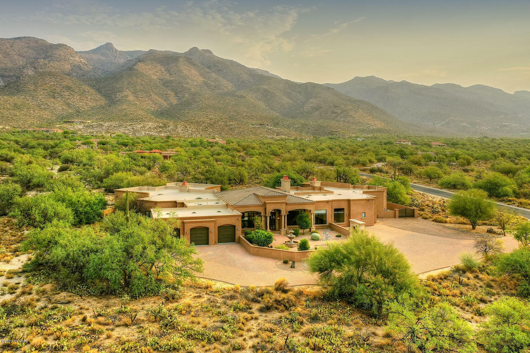 Exquisite 5 Bedroom & 7 Bath Mediterranean custom home on 3.31 acres in secluded gated community tucked against the Catalina mountains offers only the very finest- it is Move in ready!   The 6600 square foot homed features a gorgeous courtyard entrance with a cascading Cantera stone fountain leading to a grand portal offering passage into the spacious and dramatic great room.  The eye is drawn to the 14-foot coffered and barrel ceilings, massive Cantera columns and the magnificent views.  The spacious gourmet chef's kitchen offers only the finest in Viking stainless steel appliances, massive granite island plus walk in pantry, Meile expresso machine and wine refrigerator.  The kitchen opens to the family room, media/ theater room and expansive patios.  See supplement. Exquisite 5 Bedroom & 7 Bath Mediterranean custom home on 3.31 acres in secluded gated community of Saquaro Hills Estates,  tucked against the Catalina mountains offers only the very finest- it is Move in ready and absolutely no steps.  The 6600 square foot homed features a gorgeous courtyard entrance with a cascading Cantera stone fountain leading to a grand portal offering passage into the spacious and dramatic great room.  The eye is drawn to the 14-foot coffered and barrel ceilings, massive Cantera columns and the magnificent views.  The spacious gourmet chef's kitchen offers only the finest in Viking stainless steel appliances, massive granite island plus walk in pantry, Meile espresso machine and wine refrigerator.  The kitchen opens to the family room, media/ theater room and expansive patios.  For all your entertaining needs are numerous patios, walkways, outdoor fireplace, pool, spa and outdoor gazebo with built in BBQ.     Amenities include various decorative European touches and lighting with large Cantera Stone columns, 3 massive masonry fireplaces, travertine, gorgeous hand-hewn alder doors with fine cabinetry and granite counter tops throughout.  Stunning stone and rich tiles capture interest and accented throughout this residence.  Epoxy floors in the oversize 3 car garage.  Numerous fruit trees bare harvest of fig, grapefruit, lemon, and orange wafting a sweet fragrance at different times of the year.  Truly a serene setting to enjoy the Sonoran Desert.  Arizona National Golf club minutes away.