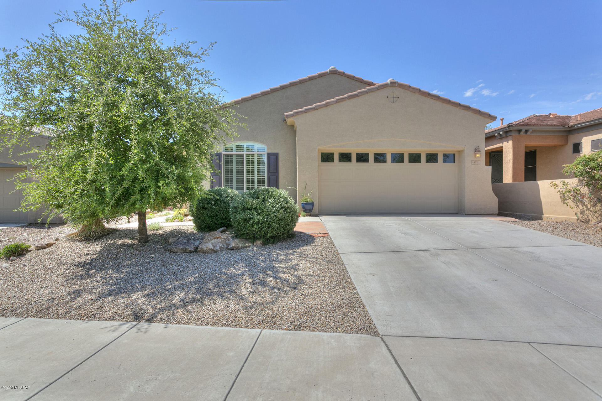 Fabulous single story home in one of Rancho Sahuarita's most sought after gated lakeside communities! Model quality, open & spacious floorplan, perfectly maintained w/loads of upgrades. 3-car ac cooled tandem garage w/epoxy floor, tile & upgraded carpet, designer touches throughout! Large open kitchen features a fabulous island, granite counters,tiled backsplash, maple cabinets & stainless appliances. 2-way fireplace in living room and master bedroom. Flexible den/dining/playroom; laundry cabinets & sink. Professionally landscaped backyard w/amazing greenery, gas grill & a screened in covered patio. Front/side courtyard is perfect for enjoying morning coffee or evening beverages. Great location close to the lake and clubhouse.