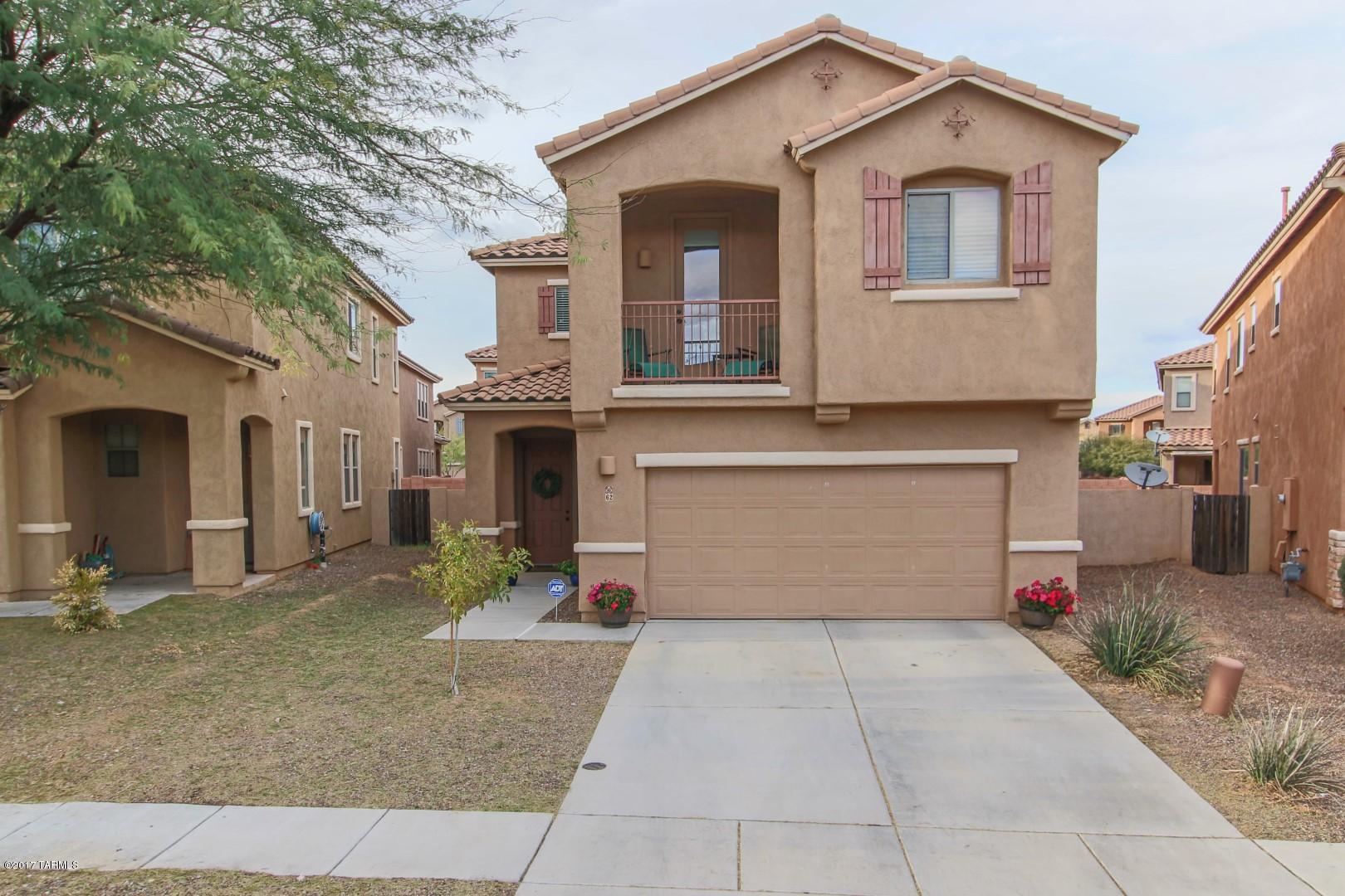 STUNNING HOME!!! 4 spacious bedrooms, 2.5 bath home will amaze the most discriminating buyer!  Soaring ceilings, lots of natural light, 18'' diagonal tile in traffic areas, with wainscoting in dining area.  The kitchen features cheery cabinets, granite counter-tops, tile back-splash and stainless steel appliances.  Exterior and interior surround sound.  Cozy gas fireplace in family room adorned with tile trim. HUGE backyard has pavers and LOTS of natural grass with sprinklers on timer for everyone to enjoy!! All this in the Award Winning Community of Rancho Sahuarita.
