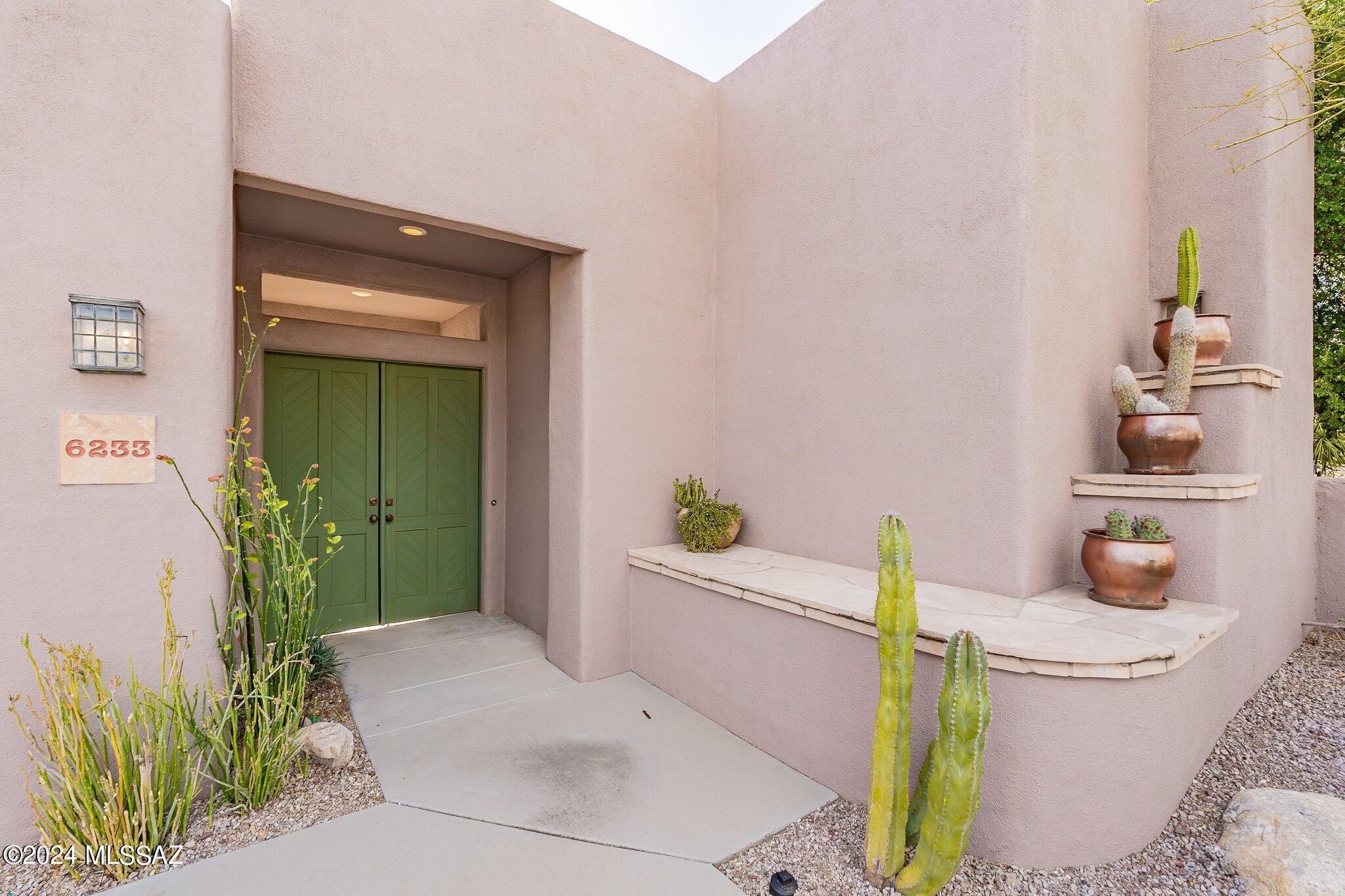 Panoramic City, Mountain, & Golf Course Views From This Single Level 3BR & 3BA Masonry Built Home in The  Coveted Enclave of The Ridge at Ventana Canyon. A Charming Courtyard Connects the 2BR/2BA Main House to The Detached 1BR/1BA Guest Casita. Located on the 12th Fairway of The Ventana Canyon Golf Course, Some of This Homes Fine Features Include: High Ceilings - Oversized Windows Offering Plentiful Natural Light - Island Kitchen w/ Granite Counters, Stainless Appliances & Gas Range - Open Living & Dining Areas w/ Natural Stone Accents - Spacious Primary Suite w/ Dual Vanity Bath, Separate Shower & Tub + Walk in Closet - Covered Back Patio w/ City, Mountain, Golf Course, & Sunset Views. This is The Best of Resort Style - Easy Lock & Go Living!