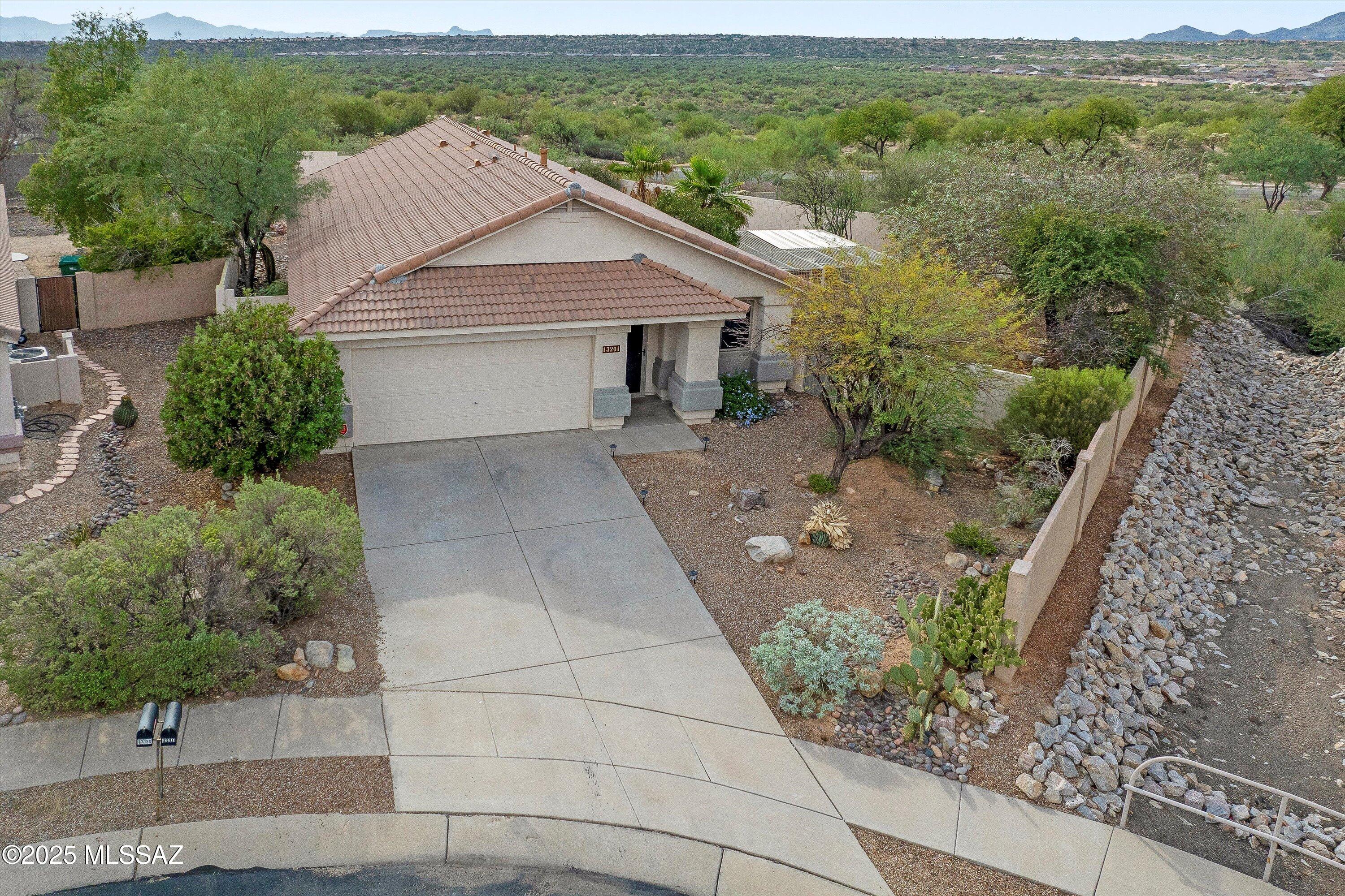 Experience the stunning vistas of Pusch Ridge and the Catalina Mountains from your large  backyard in this beautifully updated Rancho Vistoso cul-de-sac home. Inside you'll find modern neutral tone paint, an updated kitchen with granite counters, custom white cabinets, newer stainless steel appliances and modern lighting. There is wood like tile flooring throughout (carpets in bedrooms).  Updated bathrooms with tiled showers and granite vanities. Large doggie kennel with doggie door so your pets can enjoy fresh air anytime of the day. Outstanding location near shopping, dining, entertainment, medical, Catalina State Park and all that Oro Valley has to offer. And don't forget the fabulous VIEWS from one of the biggest lots in the neighborhood.