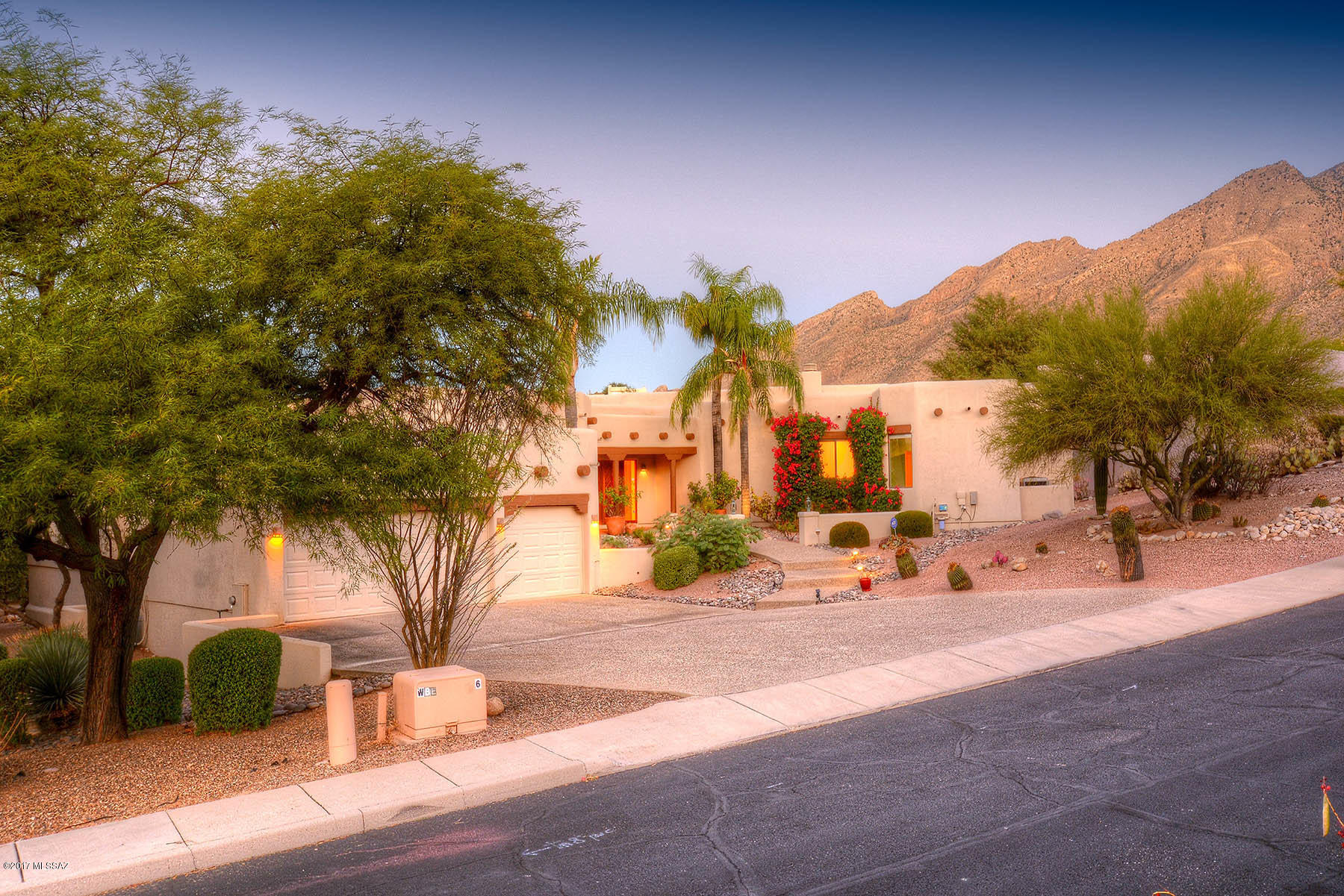 Custom contemporary Santa Fe with sweeping golf course and mountain views on the 11th fairway of the Ventana Canyon - Canyon Course. Open bright floorplan with huge picture windows to capture the views from every room. Wood-beamed high ceilings, brand new 30K kitchen appliances featuring SubZero and Wolf stainless appliances, new sink, dishwasher and microwave + Corian counters. Solid wood Douglas Fir interior doors, greatroom, family room and brakfast area + large island kitchen. New interior paint, 3 fireplaces, intercom, central vac, jacuzzi tub, auto-rolling shutters and Hunter Douglas blinds. Expansive wood beamed covered brick-on-sand patios, built-in gas BBQ, pool/spa overlooking the golf course and mountain views. Newer upgraded mechanical systems and  aggregate concrete driveway.