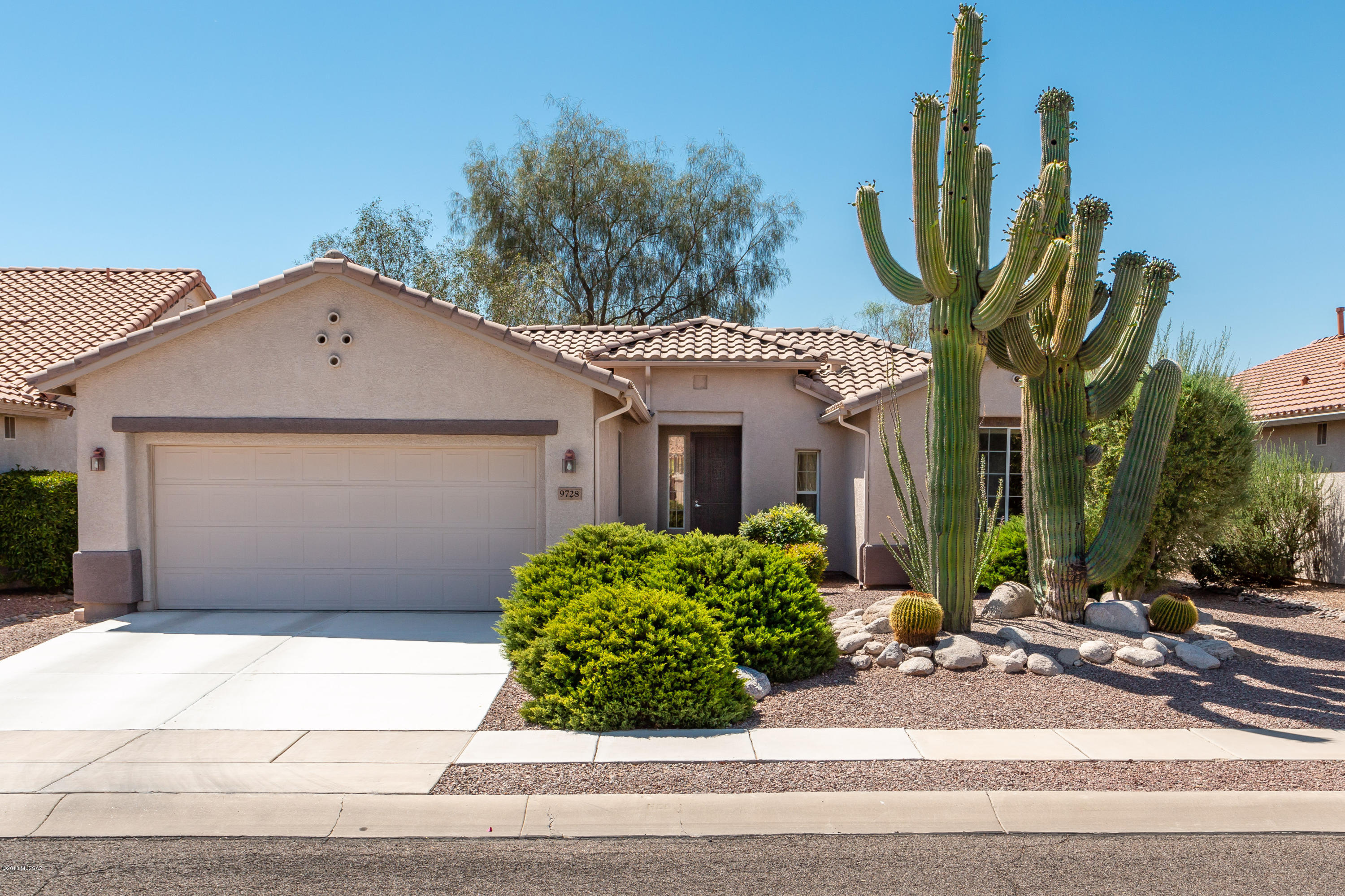 Beautiful, gorgeous, well-maintained and highly-upgraded San Carlos model home. Two bedrooms, 2 baths, den, hobby room and 2-car garage. The front entry feels thoroughly balanced and anchored by a trio of mature Saguaro cacti. A wall of windows allows an abundance of natural light and makes the home inside bright and airy. The kitchen includes granite countertops paired with stainless steel appliances, reverse osmosis, newer dishwasher and range hood. Neutral 20'' ceramic tile in the main living space with carpet in the bedrooms provides a comfortable balance. The master suite includes dual vanities and walk-in closet. Lovely backyard with extended covered patio and extended pavers has an open feeling making it a perfect oasis. Also included are newer HVAC, water heater and water softener.
