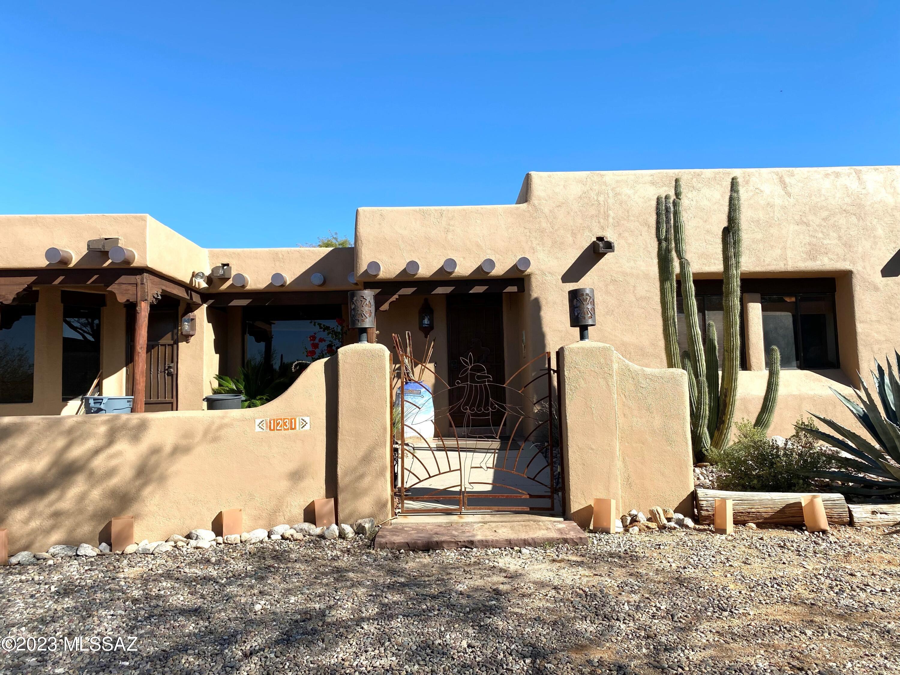 This beautiful Santa Fe home is located in the desirable Shadow Hills Neighborhood in a premium Catalina Foothills location. Mountain views, large yard with pool & spa, sports court and custom metal work throughout. Attached guest quarters has a separate bath and private entrance. Front and rear covered patios, granite counters, tile and brand new carpet in all bedrooms. New roof,  A/C and sewer line. Ready for your Foothills lifestyle to begin.