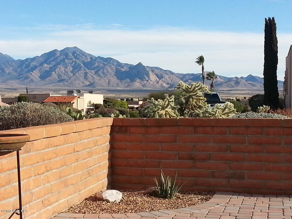 End unit in ''sweet spot'' in quiet Desert Hills 4 has fabulous panoramic views and a smashing dead on view of Elephant Head! Sturdy block construction with covered entry foyer boasts a gas log FP in living/great room, gorgeous updated baths, all ceramic tile floors and the very important brand new heating and cooling system. All matching GE appls & smooth top electric range in the eat-in kitchen with a garden window. Move in without a care. New professional arid landscape in front. Spacious backyard hardscaped with cobblestone. Covered rear porch is assessable by living room & MBR suite. Stack washer & dryer included. Lots of storage. Re-textured ceilings & walls. Easy care full time living or part time, just lock and leave. Desert Hills rec center down the street & guest parking out