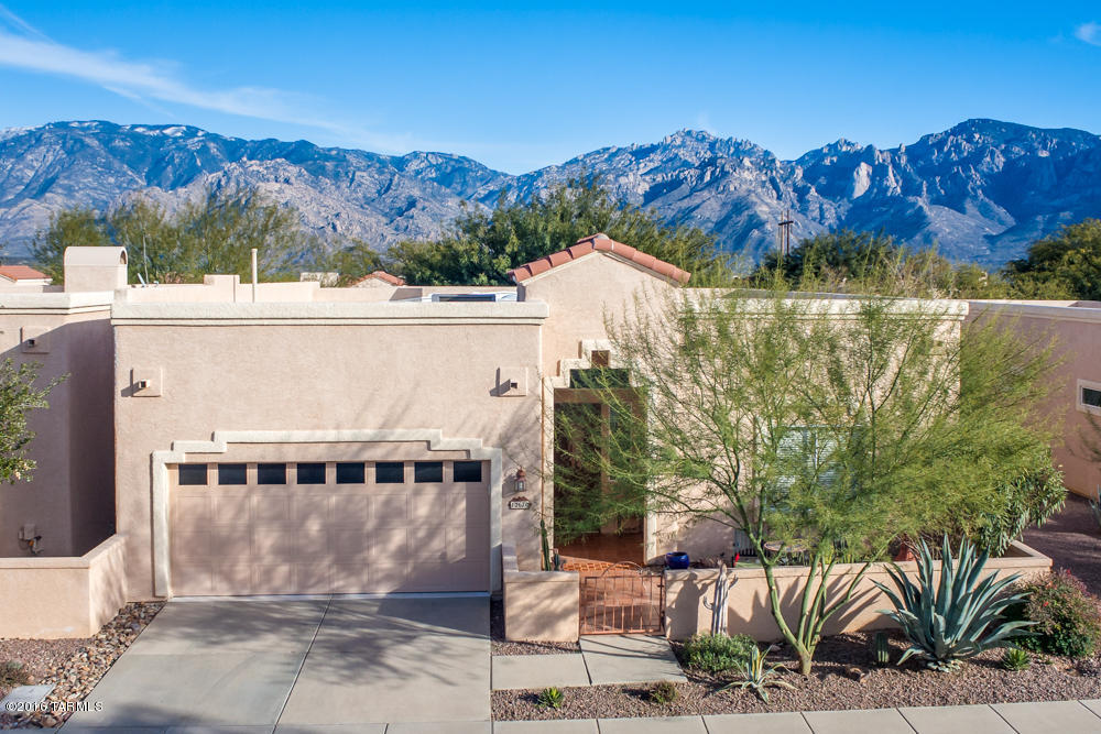 Semi custom patio home in exclusive gated Vistoso Hills Community. Sought after end unit. 2164 sf, 3 bedroom, 2.5 bath with lots of natural light & vibrant colors. Large master with his & hers walk in closets and dual vanities. Abundant storage thru out home. Enjoy your morning coffee on the private rear courtyard. Custom gas Kiva for chilly evenings and spiral staircase to upper deck for mountain views and sunset. Garage is epoxy coated. Roof coated in 2015. Community painted in 2016 & 2017 with updated colors. Call to view the many features this home has to offer. Furniture available by separate bill of sale. Community pool, spa, and clubhouse with panoramic mountain views of the Catalina Mountains.