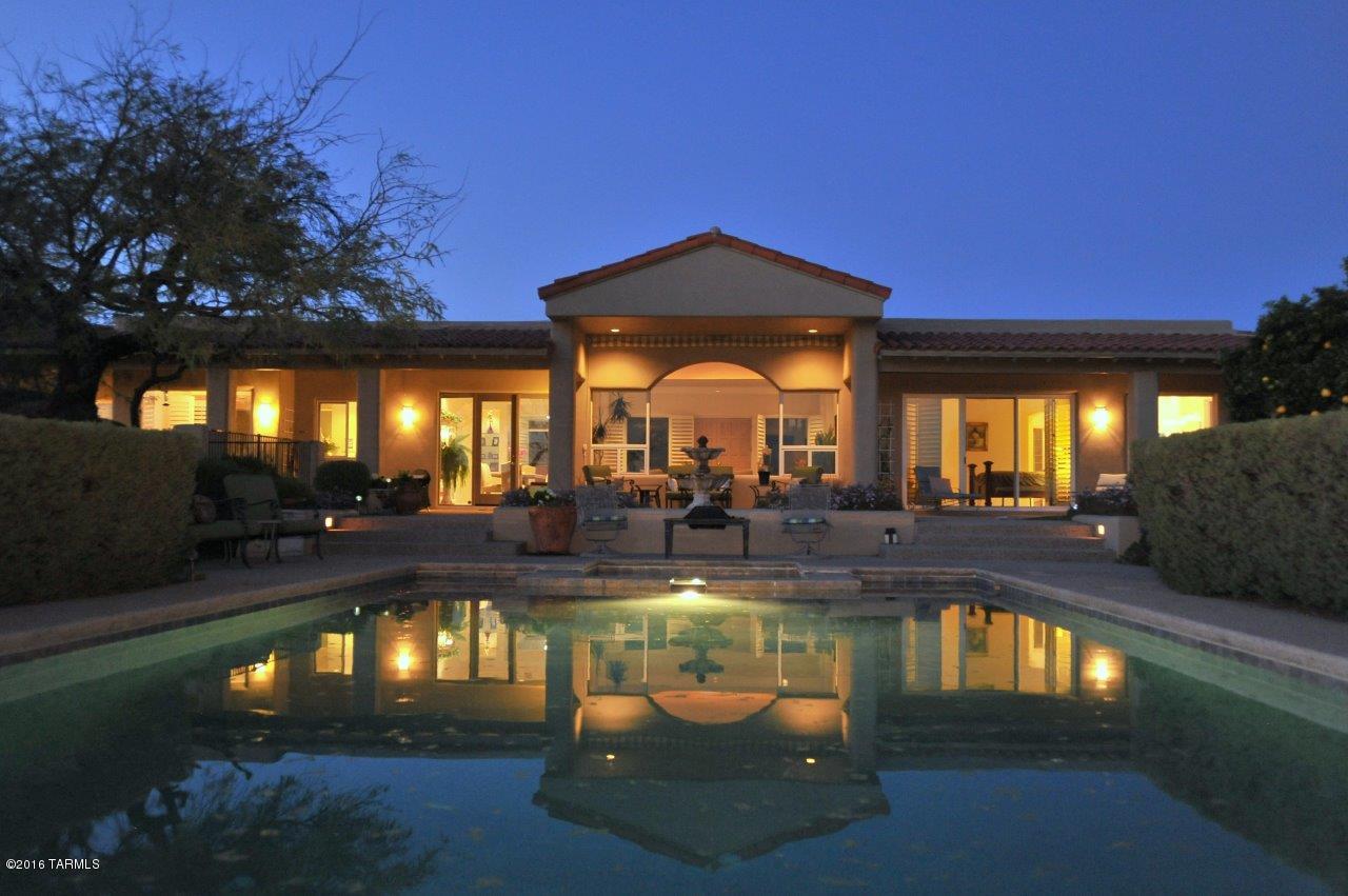 Wonderful privacy and spectacular views abound from this lovey home on 1.2 acres. Situated in a hard to find quiet gated community of only 27 homes. This custom home with no steps is on a high view lot with open space below and on three sides. Another home cannot be built below. There are several covered private patios and spaces to experience the peaceful setting. Enjoy formal and informal living spaces with a great kitchen and comfortable family room as well as a commercial type wine cellar and formal dining. There is a resort like pool and spa for entertaining as well as a putting green, mature grapefruit tree and lush but low maintenance landscaping. This home is perfect for a family or a winter visitor! Seller has spent over $200,000 renovating and making
