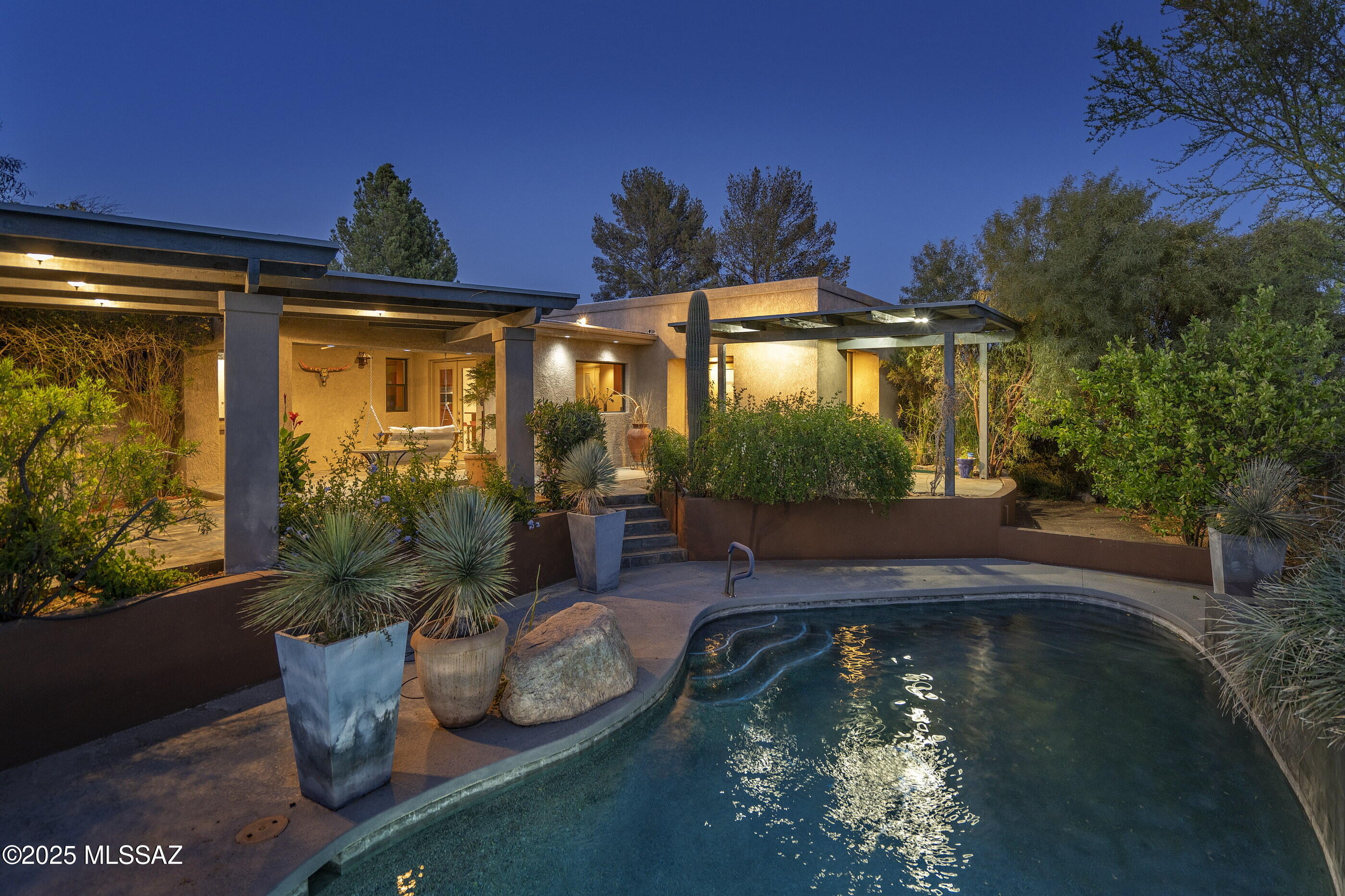 Privately situated in the Foothills at the end of a Cul de Sac, is a beautiful, charming home with rental income producing Guest House, privately gated on a 1.14 Acre Lot  The main house has been remodeled and a Guest House added.  There is a 1331 sq ft 4 car garage   Kitchen beautifully remodeled.  New cherry stained wood cabinets with Stainless Steel appliances and an amazing American  Standard Red range: 6 burner, 2 ovens. Beautiful  .There is a breakfast bar and informal dining area. Resort style back yard with beautiful pool,, outdoor bar, lush landscape , Koi pond and city views.. Charming Guest House, furnished. 2 bdrms   Used as a short term rental. Income  producing property easily rented.  No HOA  Great location, exceptional property!