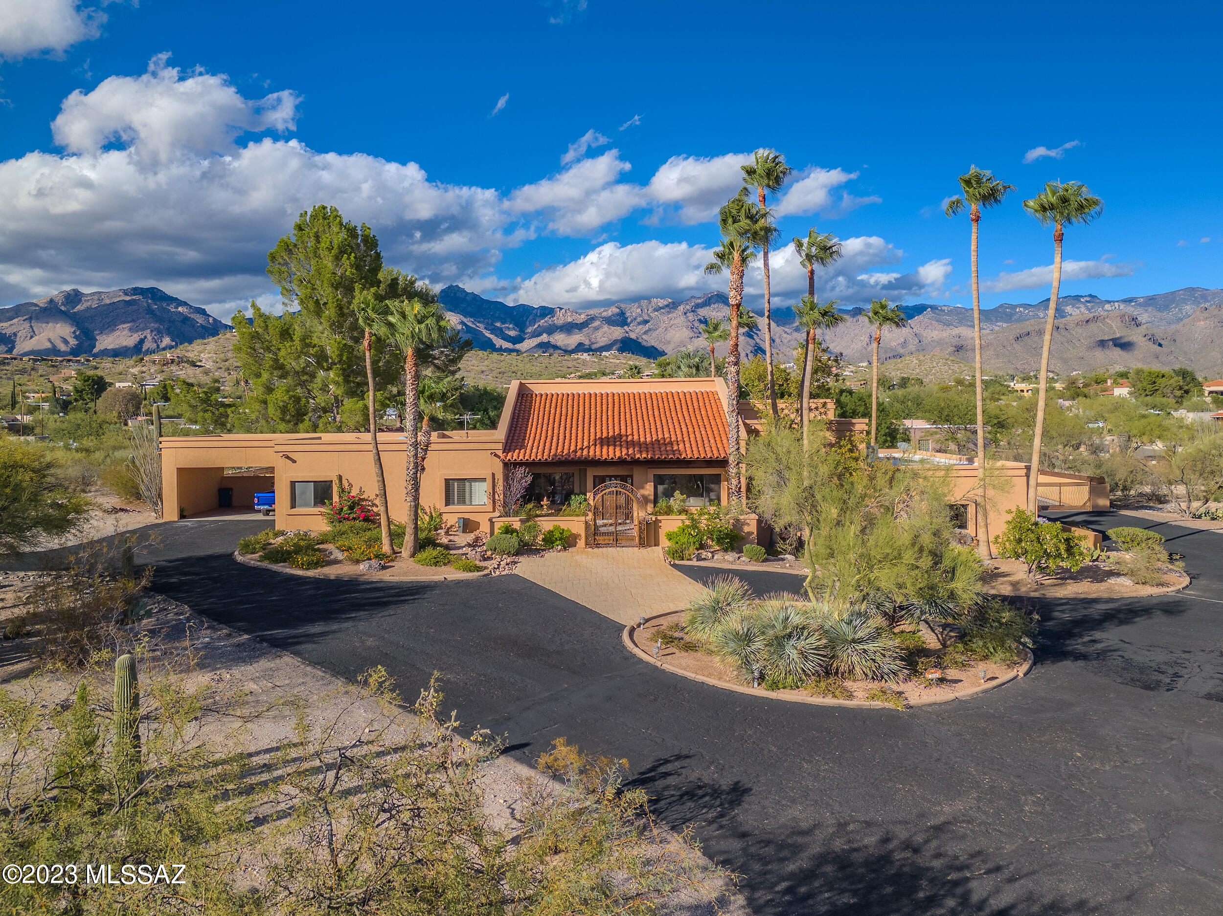 Embark on a life of luxury and recreation in this exquisite 5-bedroom retreat, a mere heartbeat away from the renowned Canyon Ranch. Seamless design integrates living, dining, family, and game rooms, creating an ambiance of sophistication and comfort. Discover your personal oasis with a PICKELBALL/tennis court, basketball court, pool & spa, inviting endless hours of leisure. The allure continues indoors with a captivating jungle-themed office, where work seamlessly blends with inspiration. Panoramic views of the city and mountains provide a breathtaking backdrop, while a meticulously designed ramada beckons for al fresco gatherings against this stunning panorama. Elegance meets functionality in every detail, from the high-end finishes to the thoughtful layout. SELLER FINANCING AVAILABLE!!