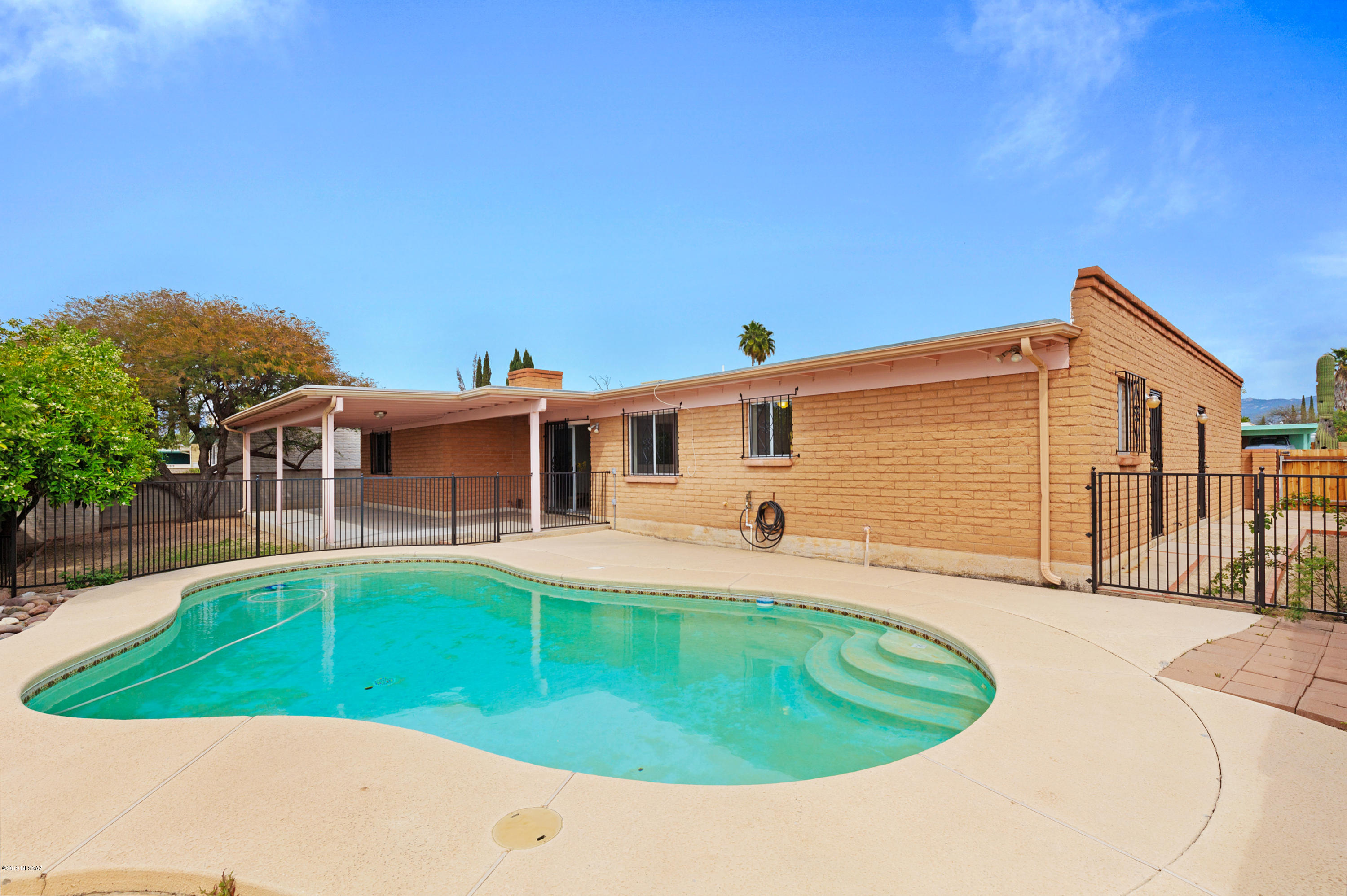 Get ready to swim this summer in this tantalizing pool.  Freshly remodeled masonry constructed 4 BR / 2 BA home has been updated to today's modern elegance.  Bright and open design that dazzles with large picture windows, gracious room sizes, new interior paint, new carpet and saltillo tile. Deluxe kitchen boasts abundant alder cabinetry, granite counter tops, SS appliances & sunny breakfast nook. Large bonus room off kitchen features walk in panty + bonus storage. Inviting family room with cozy wood burning fireplace.  Delightful backyards offers covered patio, sparkling pool, mature citrus trees, & separately fenced side yard. The perfect setting to relax and watch sunsets. This treasured home has been lovingly maintained with great attention to detail and is in pristine condition.