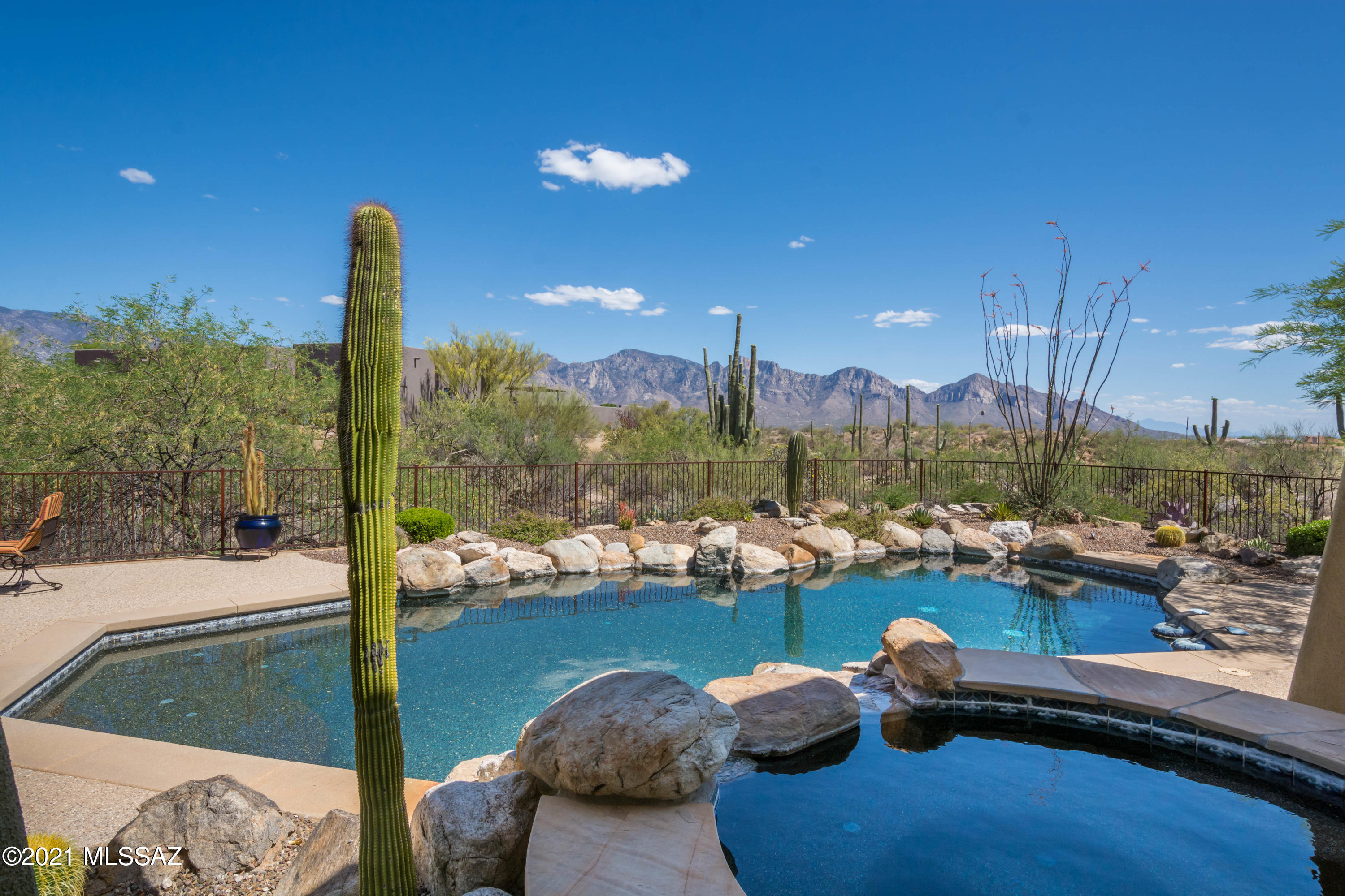 Gated Honey Bee Canyon Estates Beauty! 4BR/3 1/2 bath home w/upgrades you'll love! Newer HVAC system, regularly serviced. Gourmet kitchen w/beautiful granite, custom alder cabinets, island w/prep sink and a 15' breakfast bar! Top of the line Bosch dishwasher, Sub Zero fridge & freezer & Wolf stove/double oven. Walk in closets in all the bedrooms, large primary bedroom w/new Pella French doors & windows & a gorgeous custom built in cabinet. Primary bathroom features a large custom walk in closet, large walk in travertine shower, new Pella windows that bring in natural light & views of the beautiful backyard. Pebble tech pool & spa heated with owned solar panels! The private 1.03 lot is saguaro studded backing to lush open space & Catalina mountain views. The great room features a cozy fireplace, large Pella windows that embrace a desert oasis of lush vegetation, the deep covered patio, inviting pool & spa & the incredible Catalina Mountains. Italian travertine floors, 8ft. solid alder doors, 3 car insulated garage with tons of storage! Split bedroom floor plan.