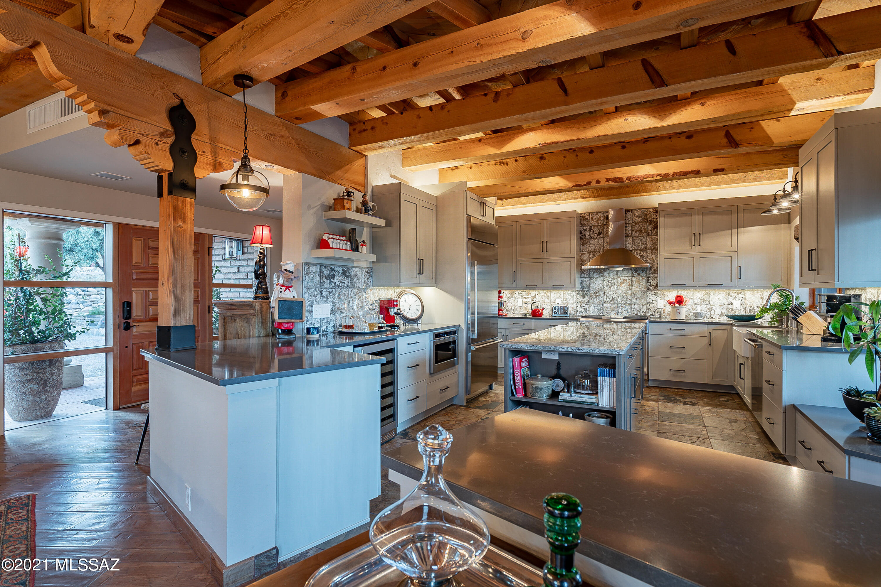 Elegance and charm abound from this classic burnt adobe territorial in the heart of the Foothills. Over 1.4 acre private lot w/ custom high-end kitchen w/ GE Monogram appliances, quartz counters & cabinetry. Cedar plank and beam ceilings adorn the spacious great room and kitchen w/ a big fireplace and Brazilian mesquite floors, slate in the kitchen and travertine in the baths.  Fabulous mountain and city views. Grand master suite w/ beehive fireplace!  Built for entertaining, the resort-like backyard has endless brick patio and walkways, built-in BBQ and a pool! New AC, new alarm, new windows in much of the house, new pool equipment and the list goes on. 2 car garage has a spacious work room attached. Only a short walk to Hacienda Del Sol, come and see the modern, rustic, farmhouse feel!